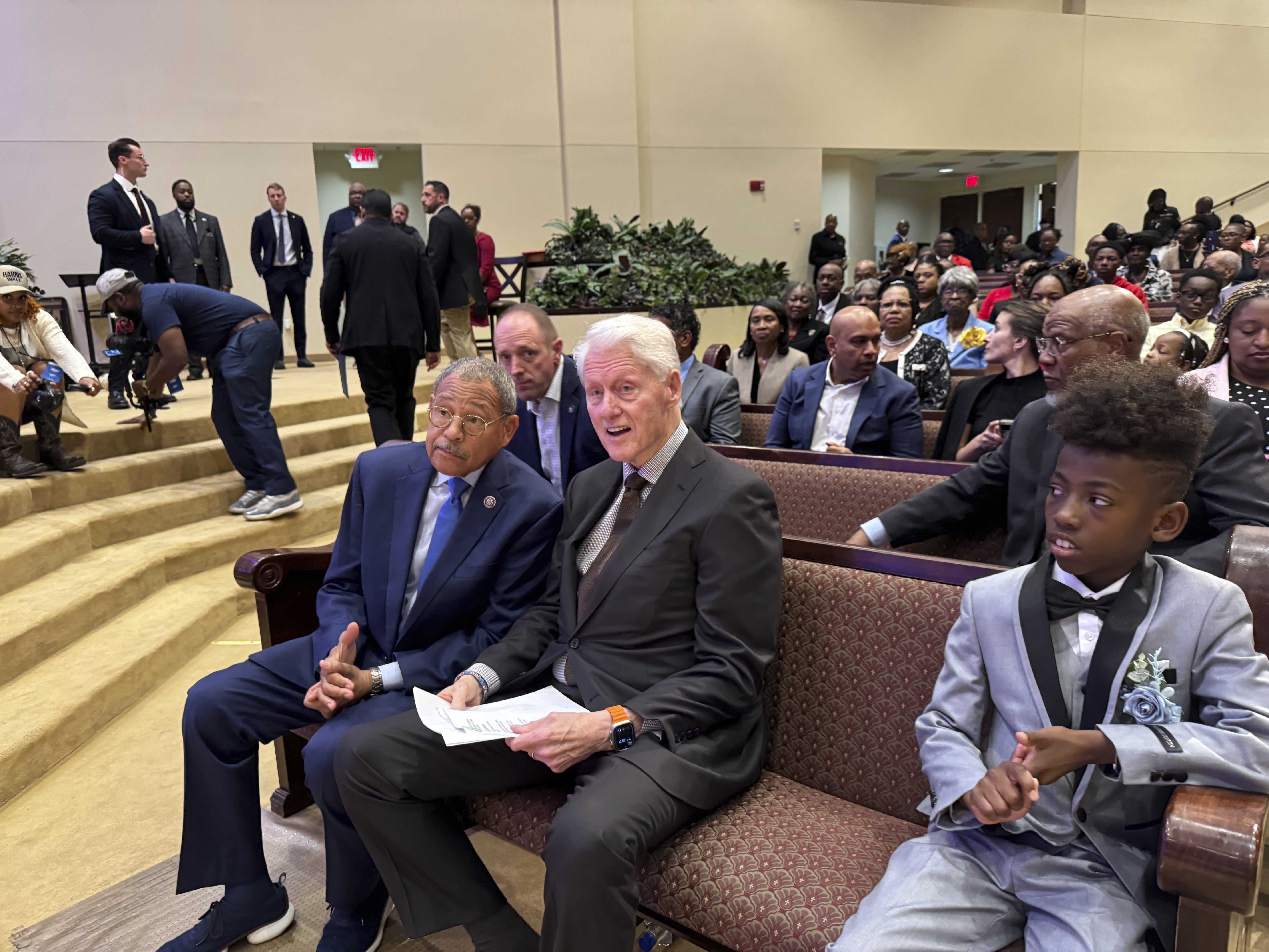 Former President Bill Clinton and U.S. Congressman Sanford Bishop talk at Mt. Zion Baptist Church in Albany, Ga. on Sunday, Oct. 13, 2024. (AP Photo/Charlotte Kramon)