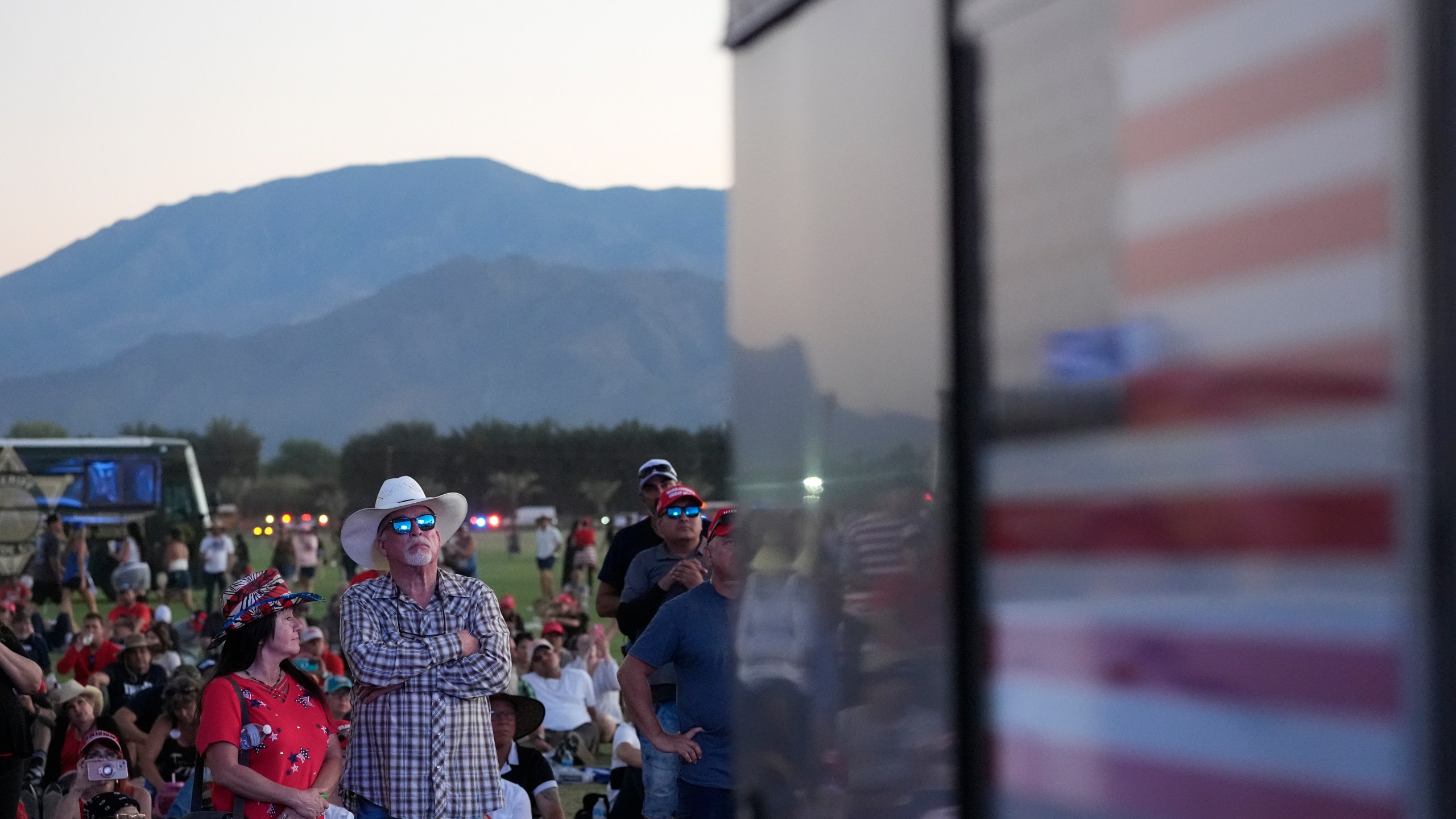 Attendees watch as Republican presidential nominee former President Donald Trump speaks at a campaign rally at the Calhoun Ranch, Saturday, Oct. 12, 2024, in Coachella, Calif. (AP Photo/Alex Brandon)