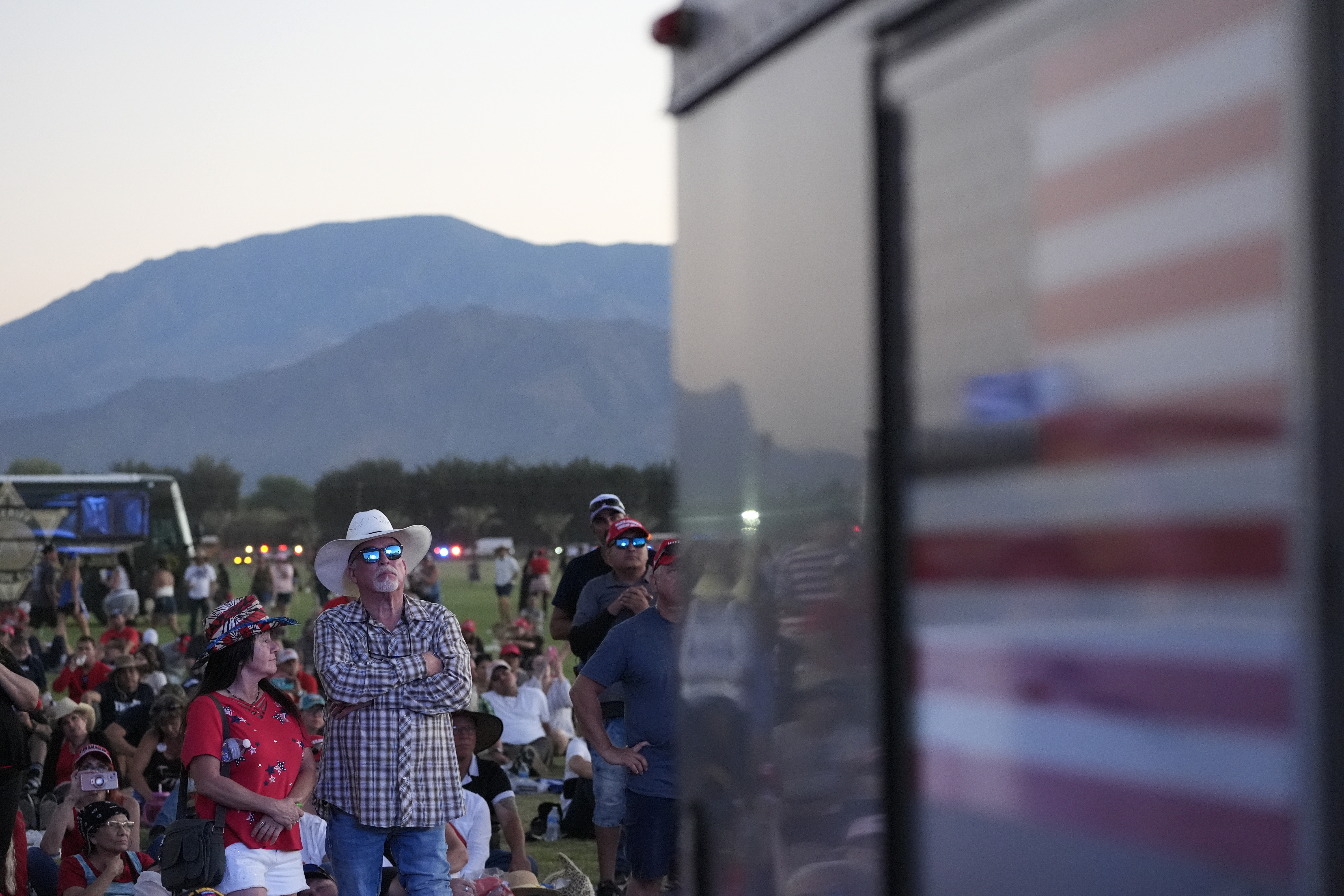 Attendees watch as Republican presidential nominee former President Donald Trump speaks at a campaign rally at the Calhoun Ranch, Saturday, Oct. 12, 2024, in Coachella, Calif. (AP Photo/Alex Brandon)