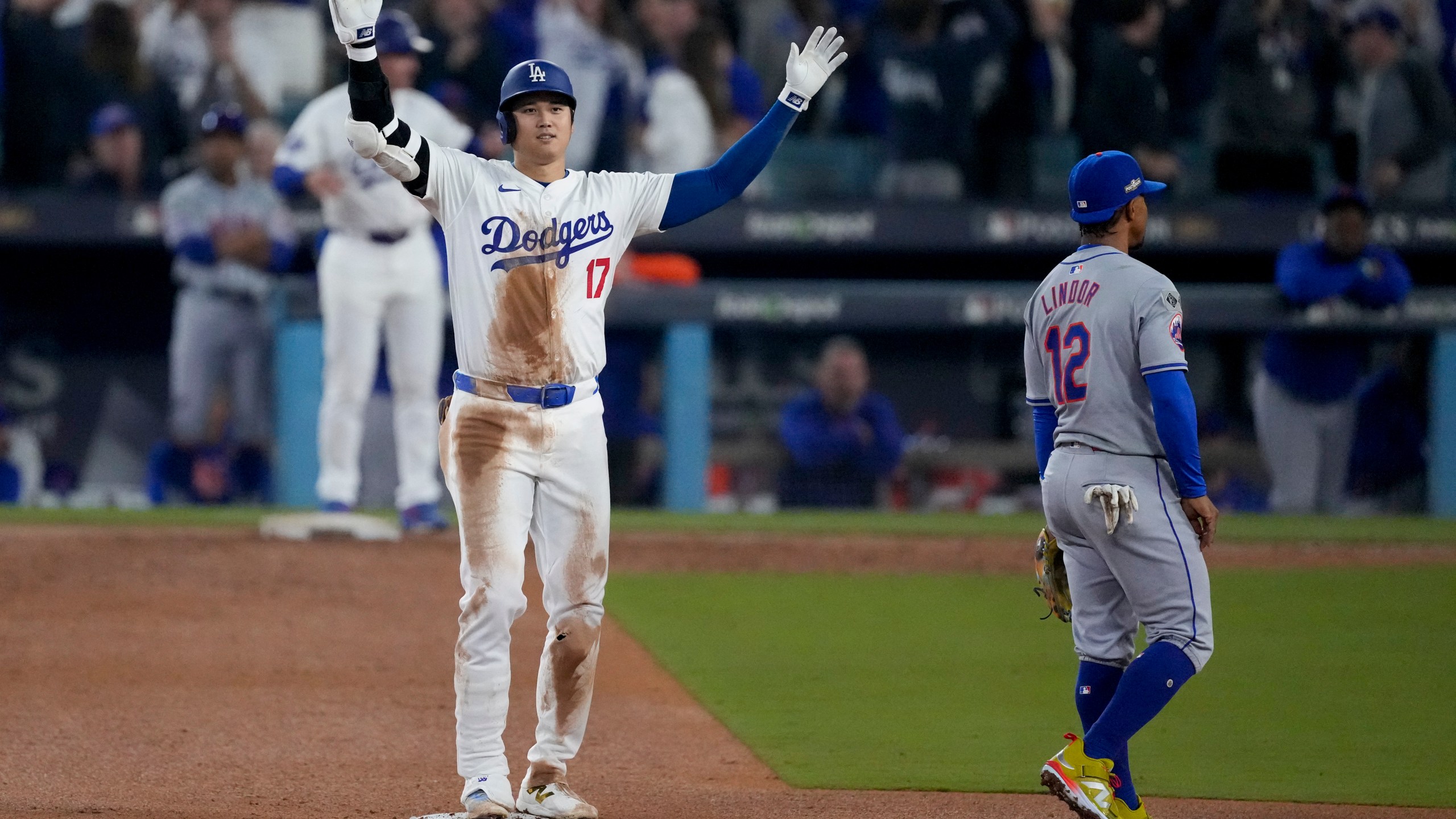 Los Angeles Dodgers' Shohei Ohtani celebrates after his RBI double against the New York Mets during the fourth inning in Game 1 of a baseball NL Championship Series, Sunday, Oct. 13, 2024, in Los Angeles. (AP Photo/Mark J. Terrill)