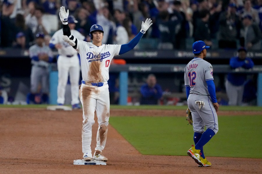 Los Angeles Dodgers' Shohei Ohtani celebrates after his RBI double against the New York Mets during the fourth inning in Game 1 of a baseball NL Championship Series, Sunday, Oct. 13, 2024, in Los Angeles. (AP Photo/Mark J. Terrill)