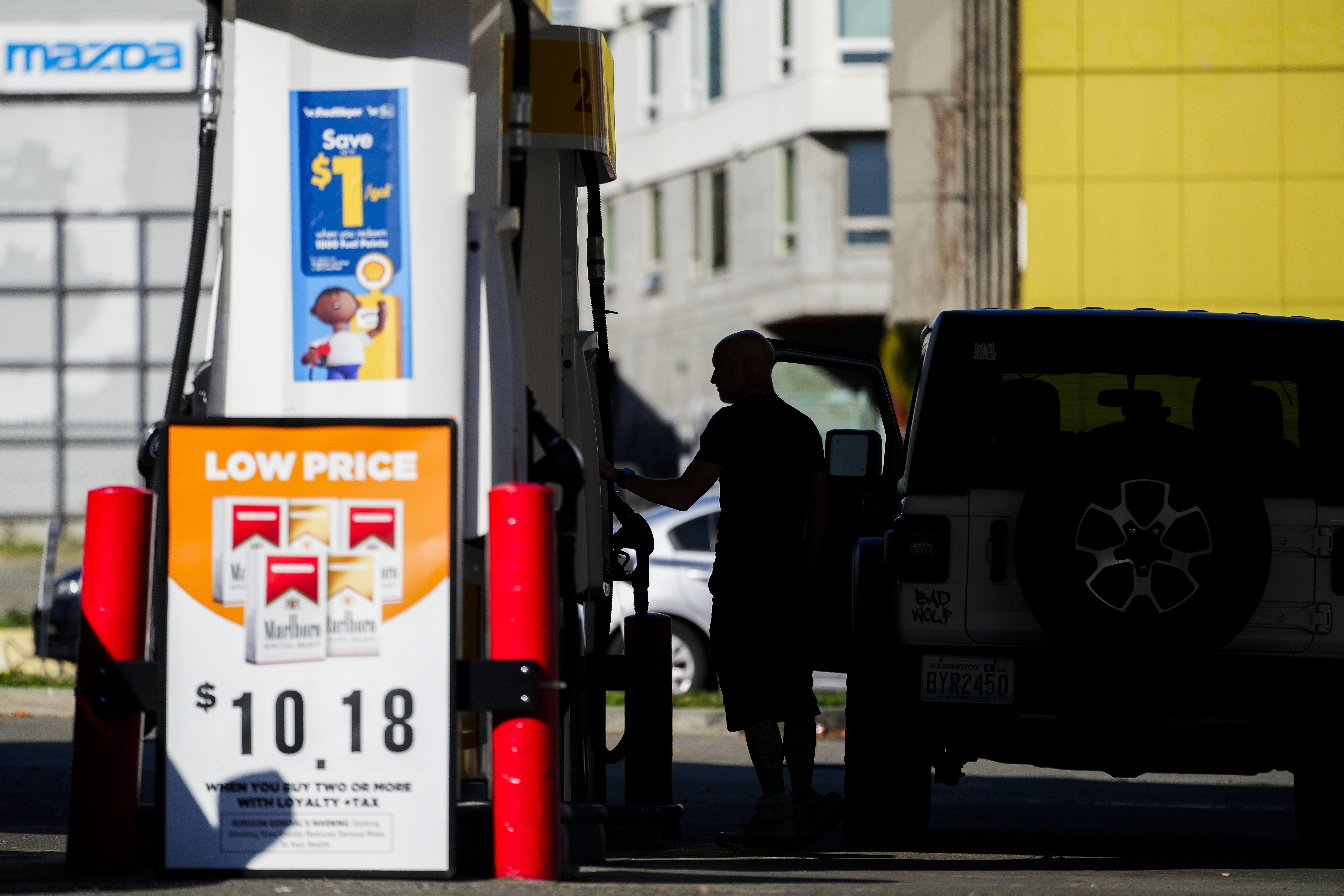 A driver fills up at a pump at a Shell gas station, Wednesday, Oct. 9, 2024, in Seattle. (AP Photo/Lindsey Wasson)