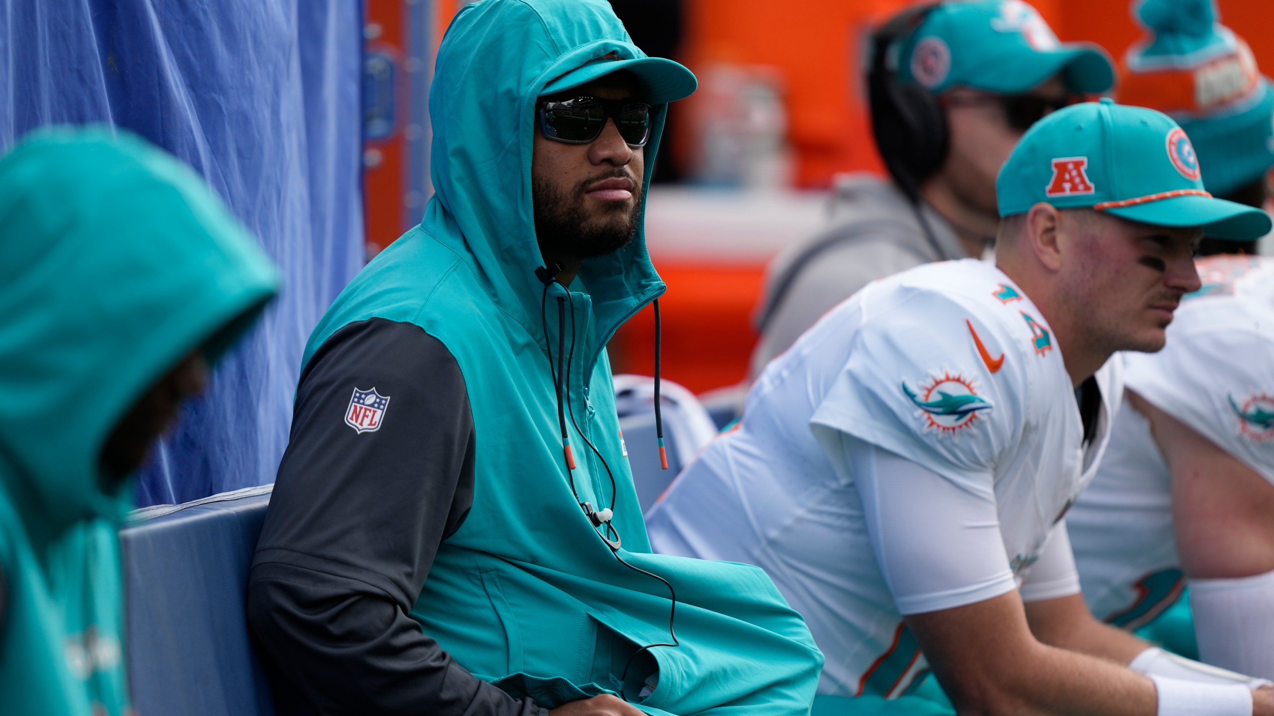 Miami Dolphins quarterback Tua Tagovailoa, center, looks on from the sideline during the first half of an NFL football game against the Seattle Seahawks, Sunday, Sept. 22, 2024, in Seattle. (AP Photo/Stephen Brashear)