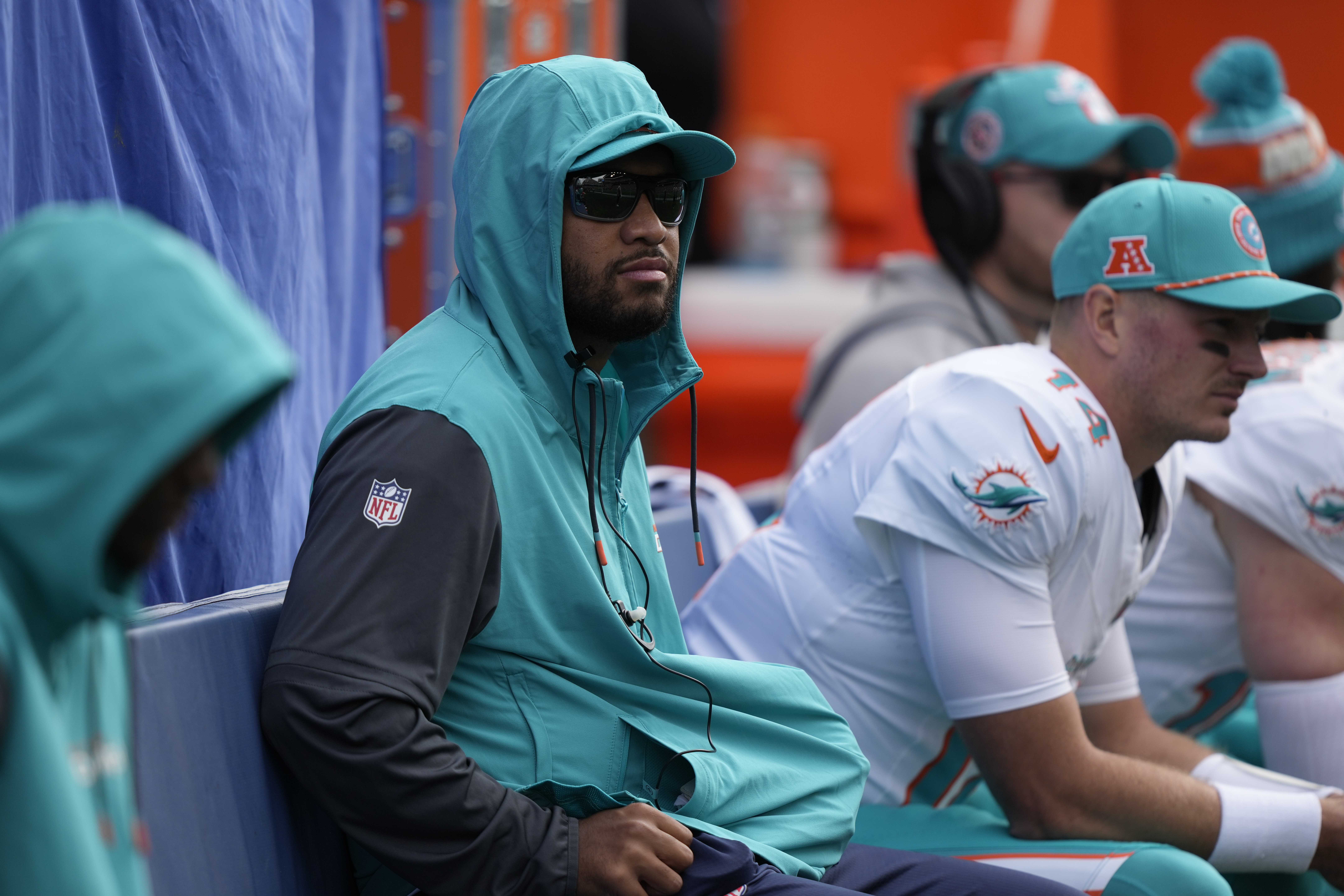 Miami Dolphins quarterback Tua Tagovailoa, center, looks on from the sideline during the first half of an NFL football game against the Seattle Seahawks, Sunday, Sept. 22, 2024, in Seattle. (AP Photo/Stephen Brashear)