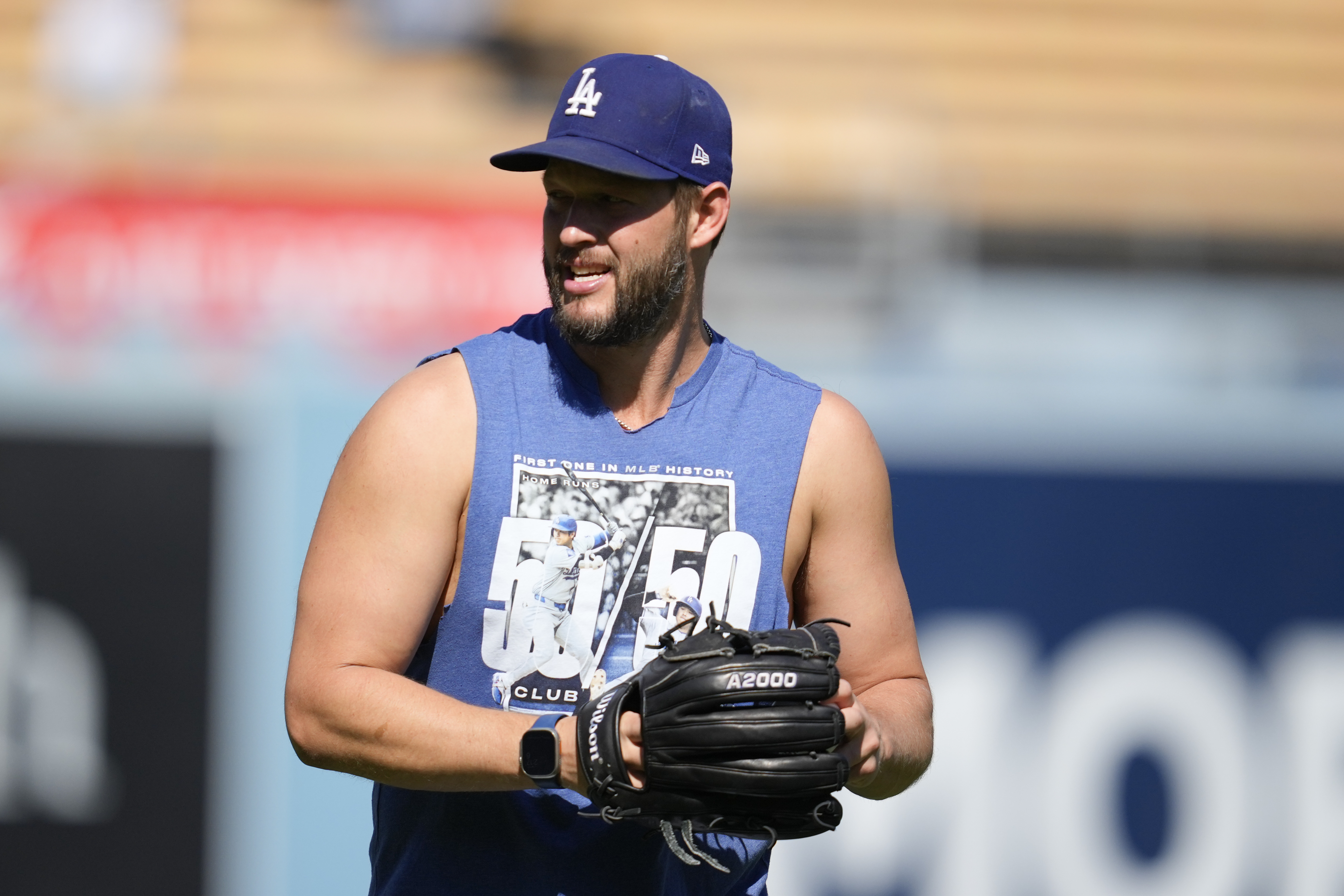 Los Angeles Dodgers pitcher Clayton Kershaw warms up before Game 2 of a baseball NL Division Series against the San Diego Padres, Sunday, Oct. 6, 2024, in Los Angeles. (AP Photo/Ashley Landis)