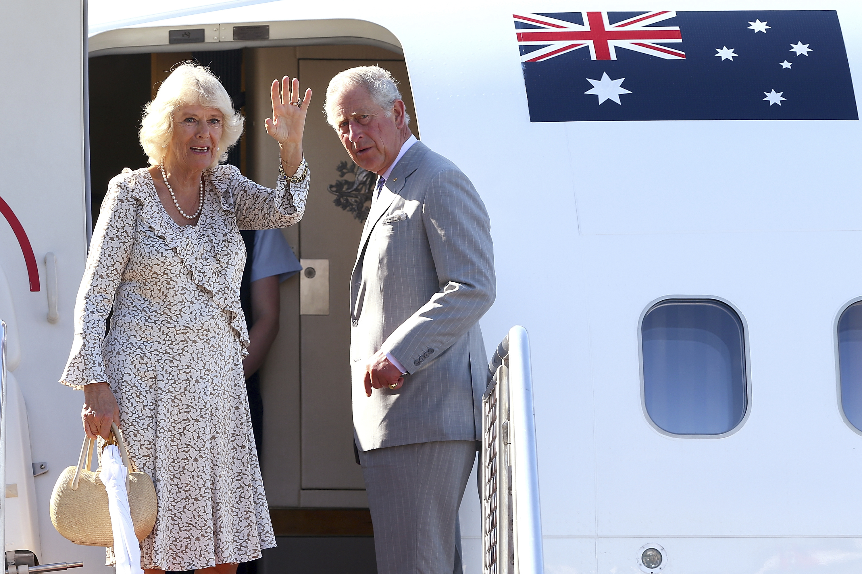 FILE - Britain's Prince Charles, right, and his wife Camilla, Duchess of Cornwall, wave as they prepare to depart Perth, Australia, on Nov. 15, 2015. (Paul Kane/Pool Photo via AP, File )