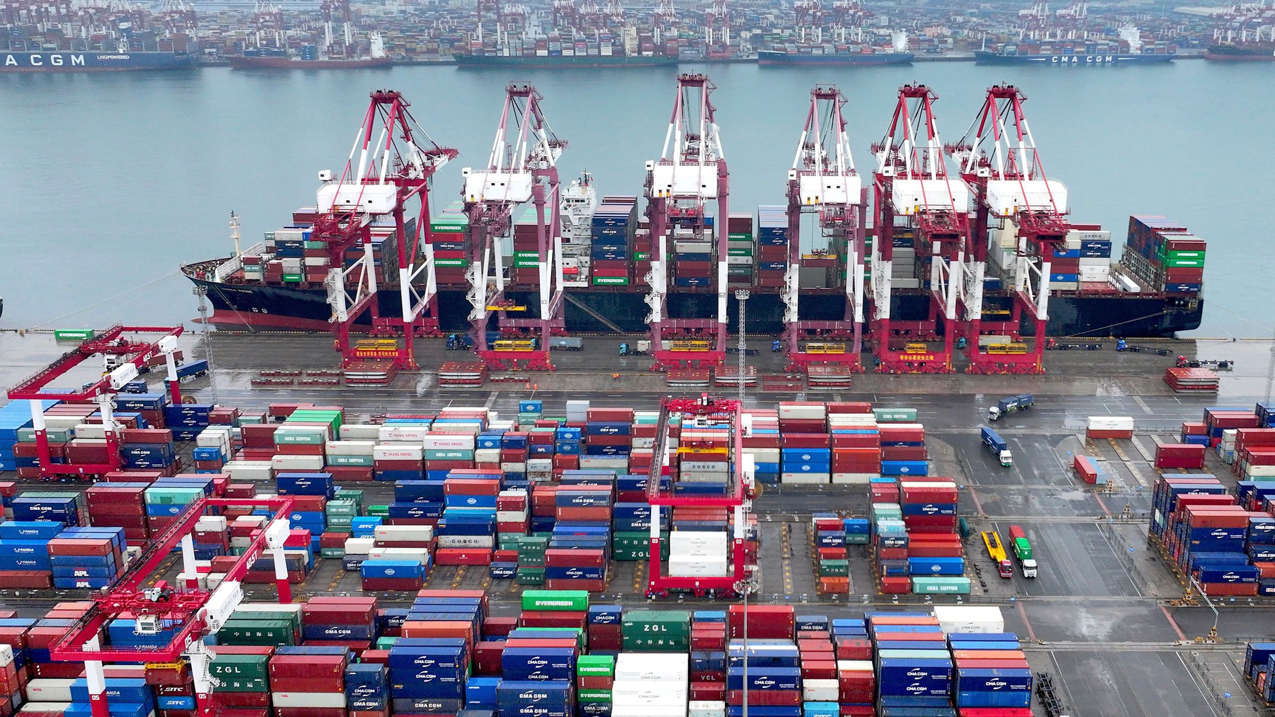 FILE - Cranes and transporters work at an automated container port in Qingdao in eastern China's Shandong province on July 7, 2024. (Chinatopix Via AP, File)