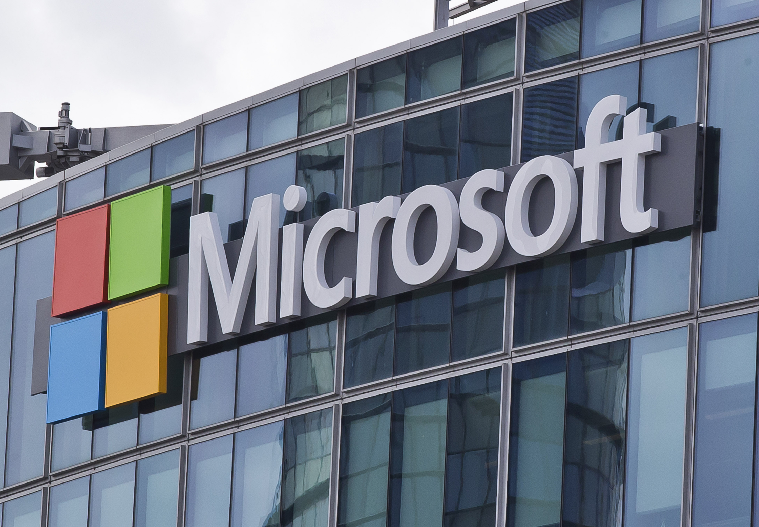 FILE - This April 12, 2016, file photo shows the Microsoft logo in Issy-les-Moulineaux, outside Paris, France. Russia, China and Iran are expanding their partnerships with cyber criminals to conduct cyberespionage and cyberattacks against the U.S. and other nations, according to a new report from Microsoft. Analysts at the tech giant say partnerships between authoritarian governments and criminal networks have benefits for both sides, increasing the volume and effectiveness of the cyber operations while giving criminals new avenues to profit and protection from prosecution. (AP Photo/Michel Euler, File)