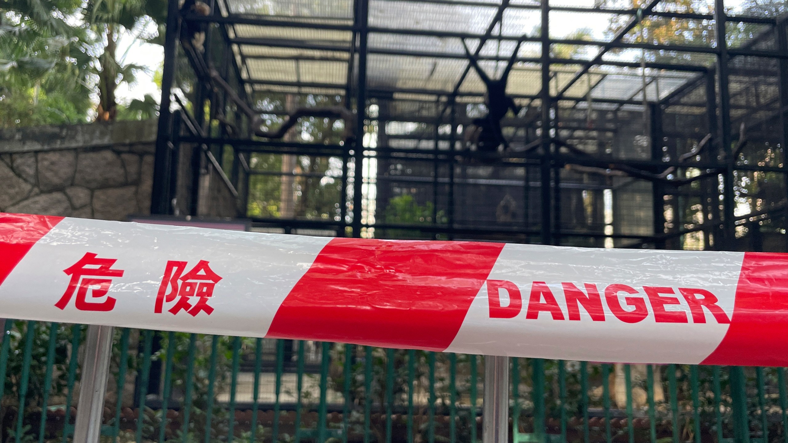 A cordon with the words danger is placed around the enclosures of monkeys after the mysterious deaths of several monkeys at the Hong Kong Zoological and Botanical Gardens in Hong Kong, Tuesday, Oct. 15, 2024. (AP Photo)