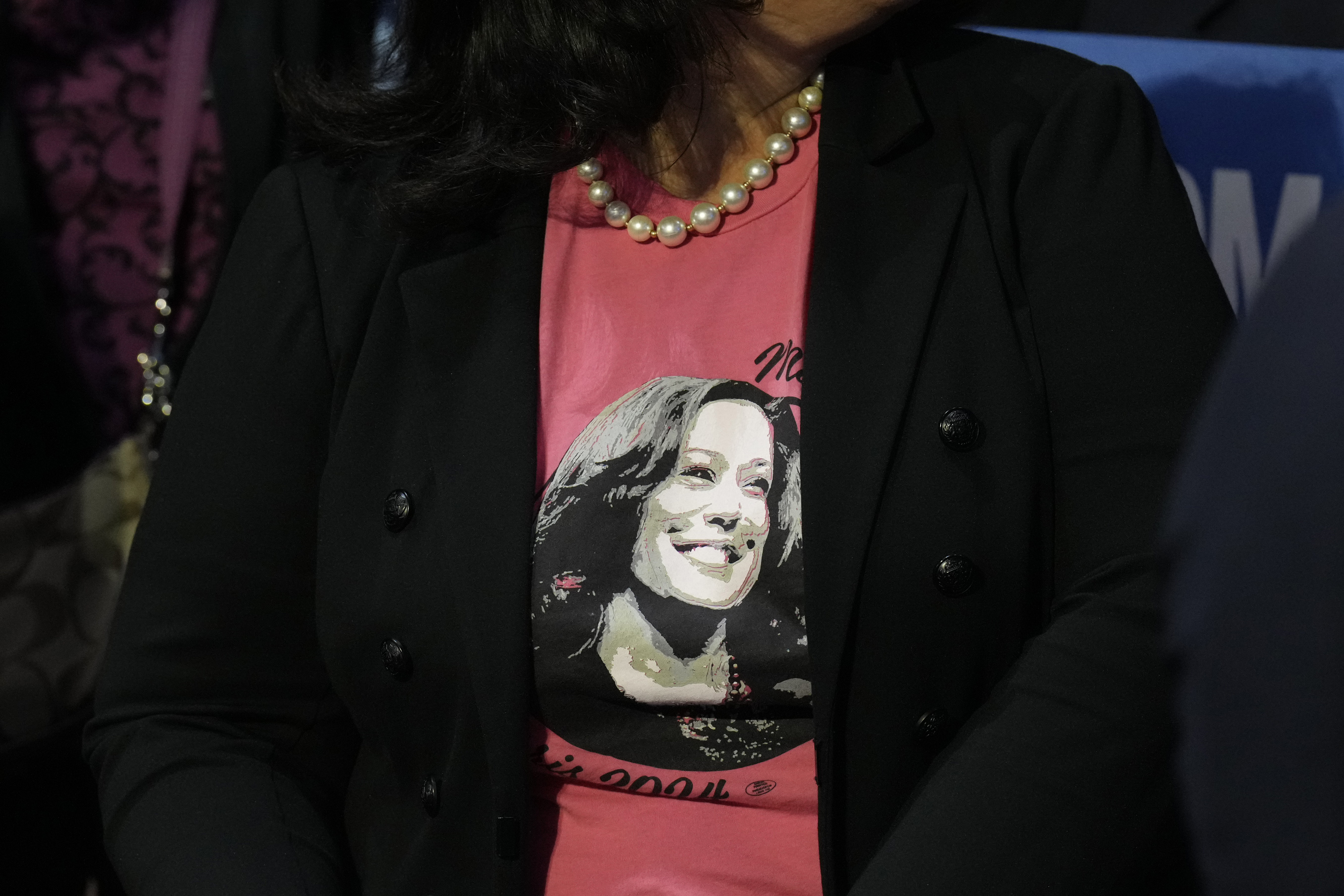 A supporter wearing a campaign-themed shirt sits in the audience at a campaign rally for Democratic presidential nominee Vice President Kamala Harris at Erie Insurance Arena, in Erie, Pa., Monday, Oct. 14, 2024. (AP Photo/Jacquelyn Martin)