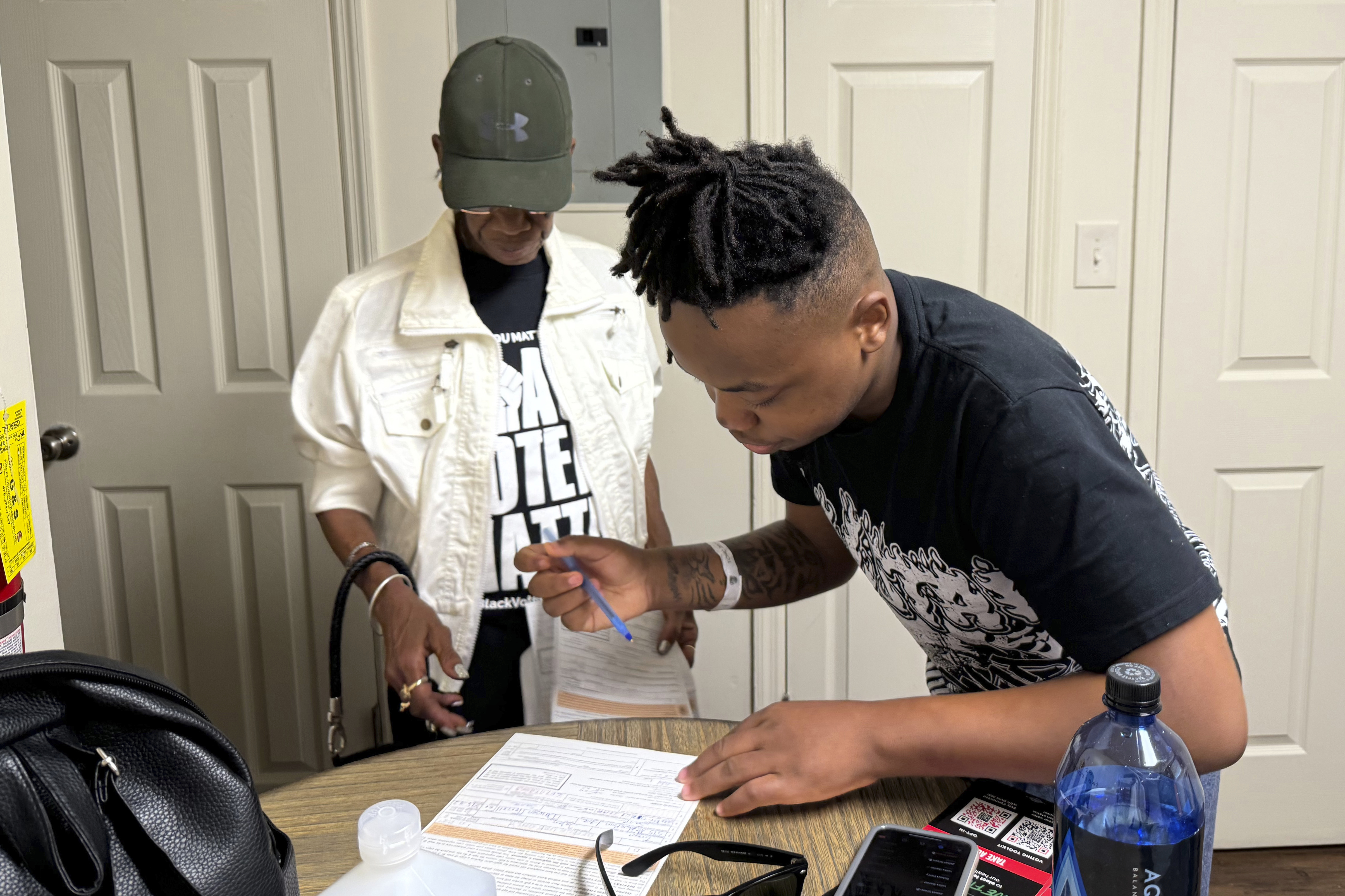 Patricia Powell helps Jaleen Green register to vote in Georgia's Terrell County on Oct. 5, 2024. (AP Photo/Charlotte Kramon)