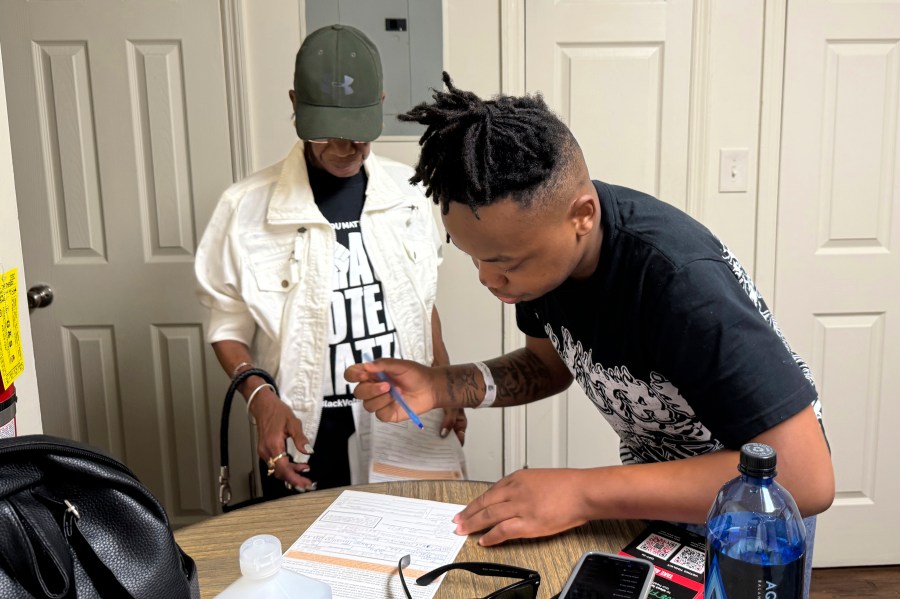 Patricia Powell helps Jaleen Green register to vote in Georgia's Terrell County on Oct. 5, 2024. (AP Photo/Charlotte Kramon)