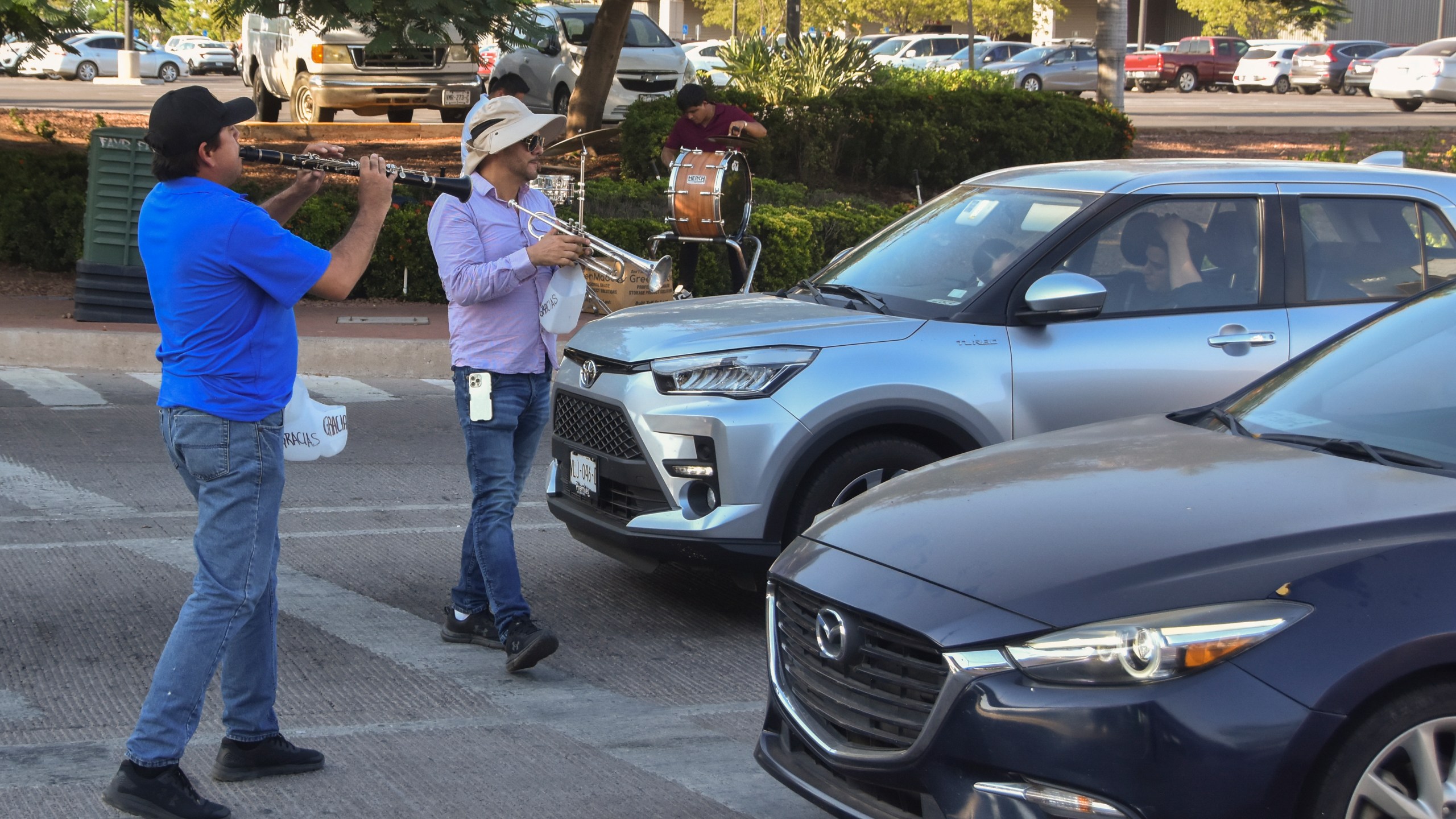 Musicians play for tips from motorists in Culiacan, Sinaloa state, Mexico, Monday, Oct. 14, 2024. (AP Photo)