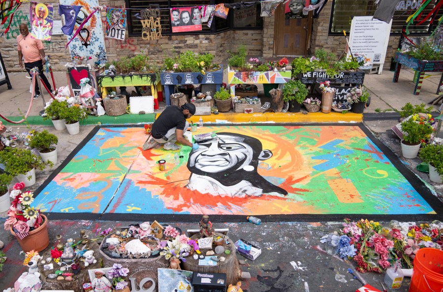 FILE - Antonio Jenkins paints a mural of George Floyd at the site where he was murdered by a police officer in 2020 at George Floyd Square in Minneapolis, May 25, 2024. (Alex Kormann/Star Tribune via AP, File)