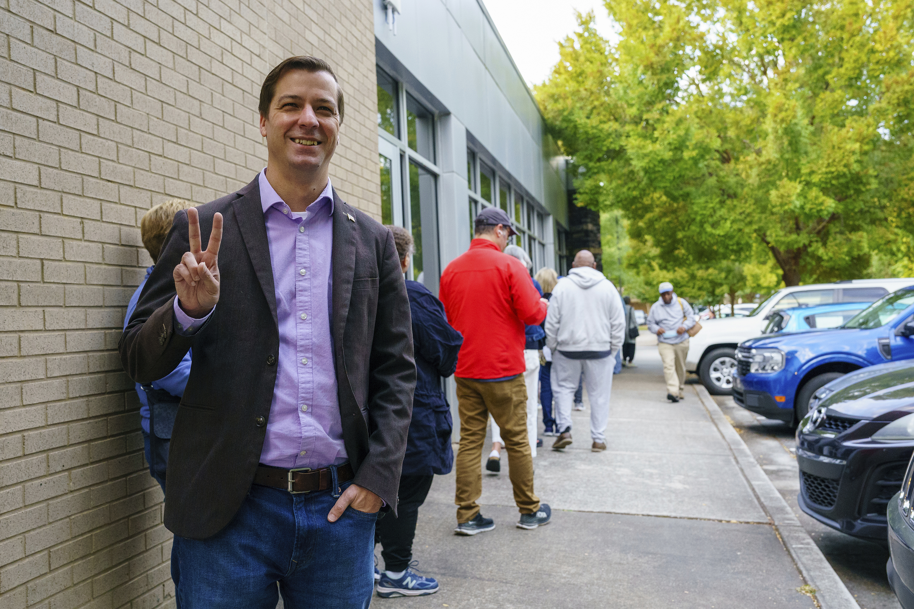 Libertarian Presidential Candidate Chase Oliver stands in line to vote at the Tucker-Reid H. Cofer branch of the Dekalb County Public Library on the first day of early voting, Tuesday, Oct. 15, 2024 in Tucker, Ga. (Matthew Pearson/WABE via AP)