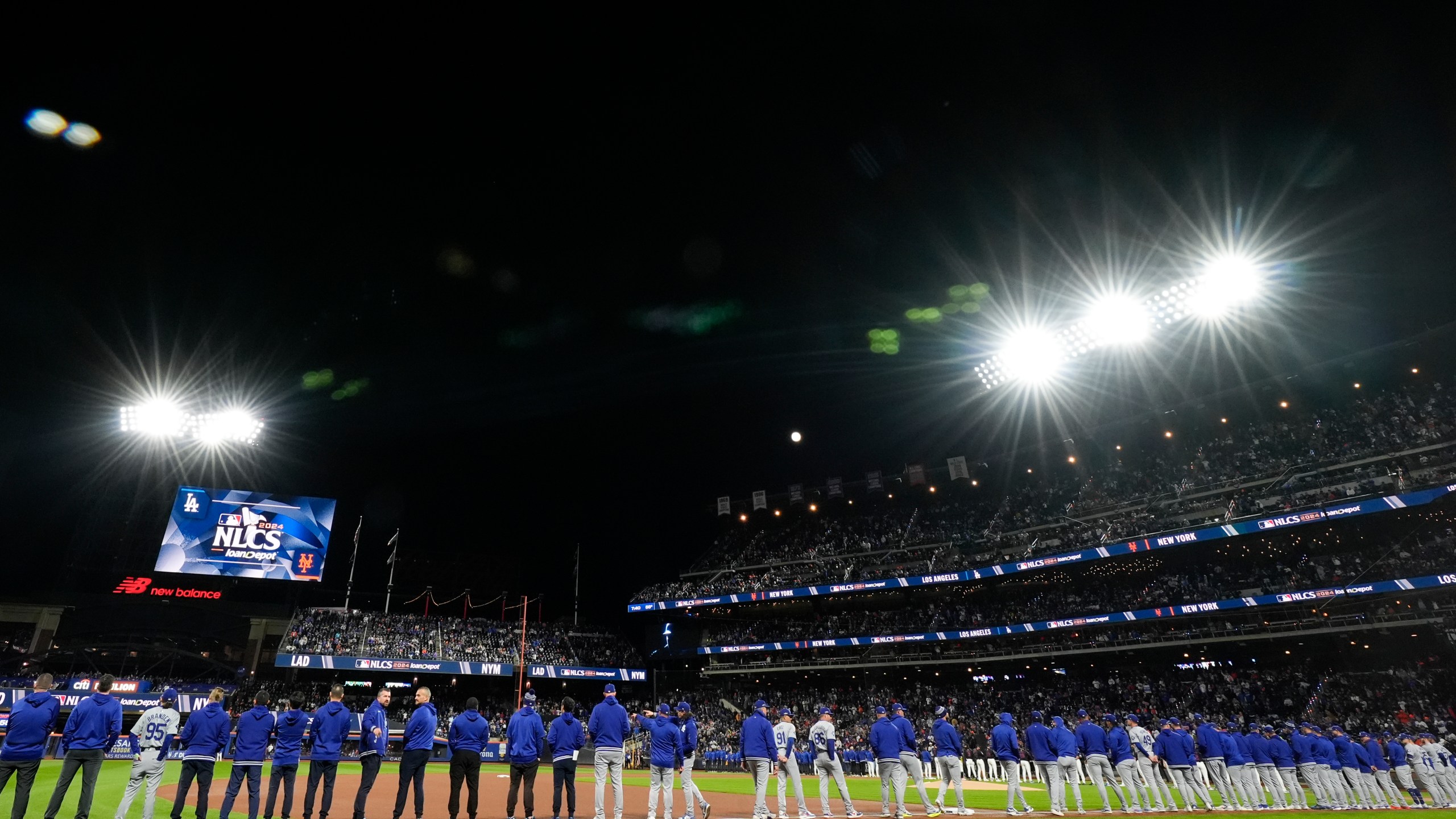 The New York Mets line up for introductions before Game 3 of a baseball NL Championship Series against the Los Angeles Dodgers, Wednesday, Oct. 16, 2024, in New York. (AP Photo/Frank Franklin II)