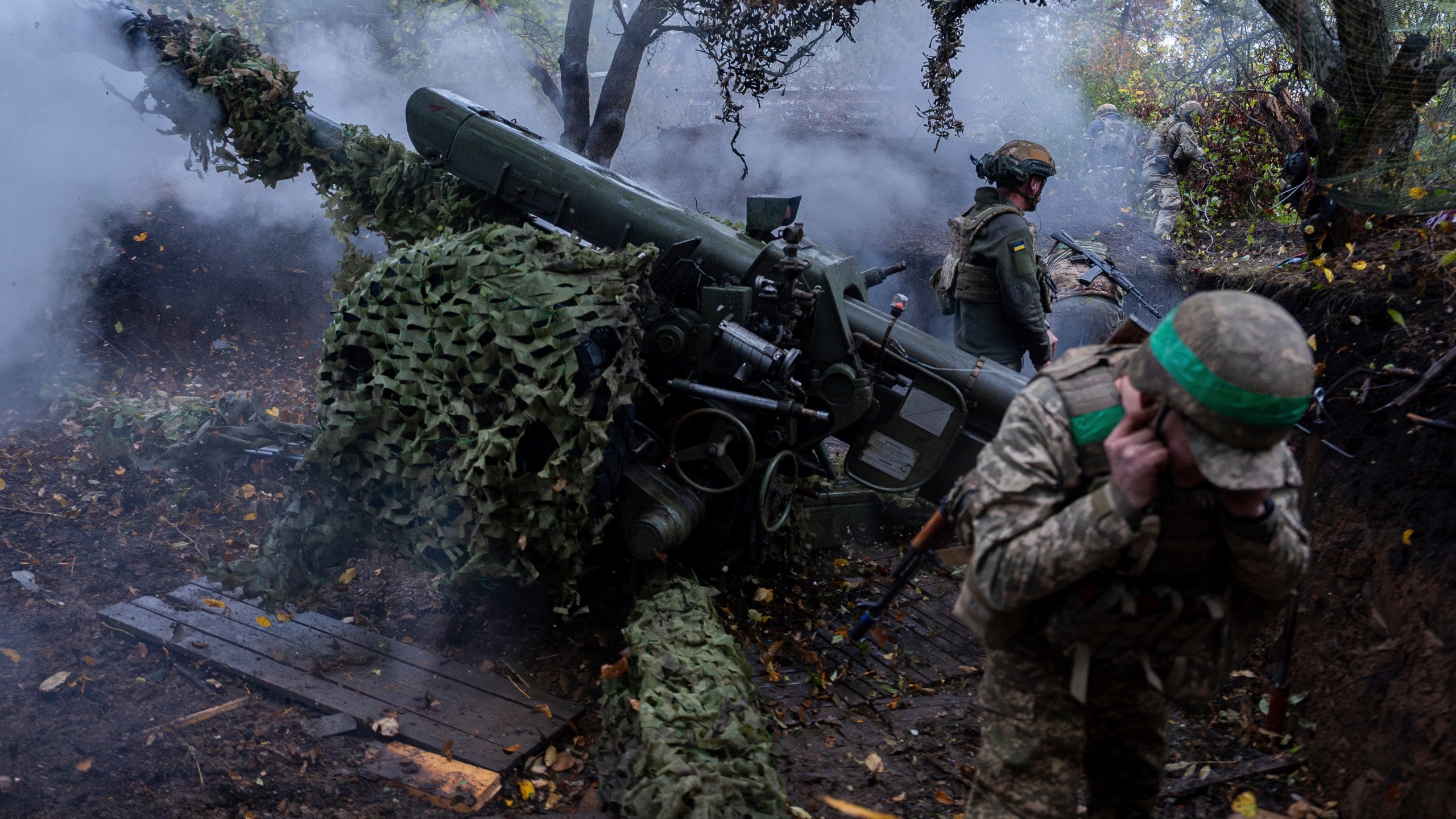 Ukrainian servicemen of Khartia brigade fire D-30 Howitzer towards Russian positions in Kharkiv region, Ukraine, Wednesday, Oct. 16, 2024. (AP Photo/Alex Babenko)