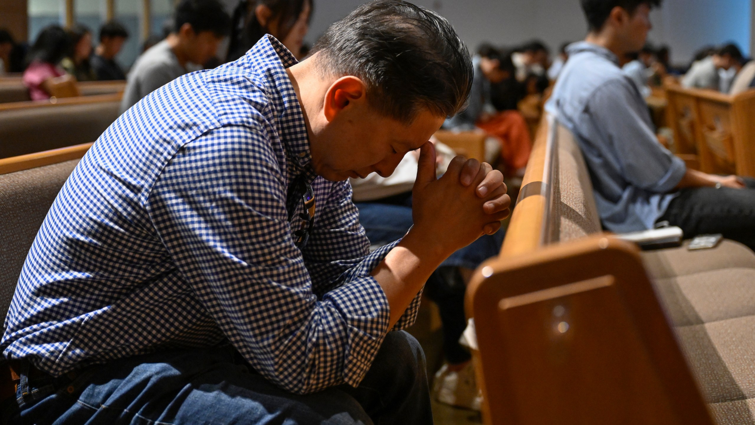 A parishioner prays during a service at the Christ Central Presbyterian Church, Sunday, Oct. 13, 2024 in Centreville. (AP Photo/John McDonnell)