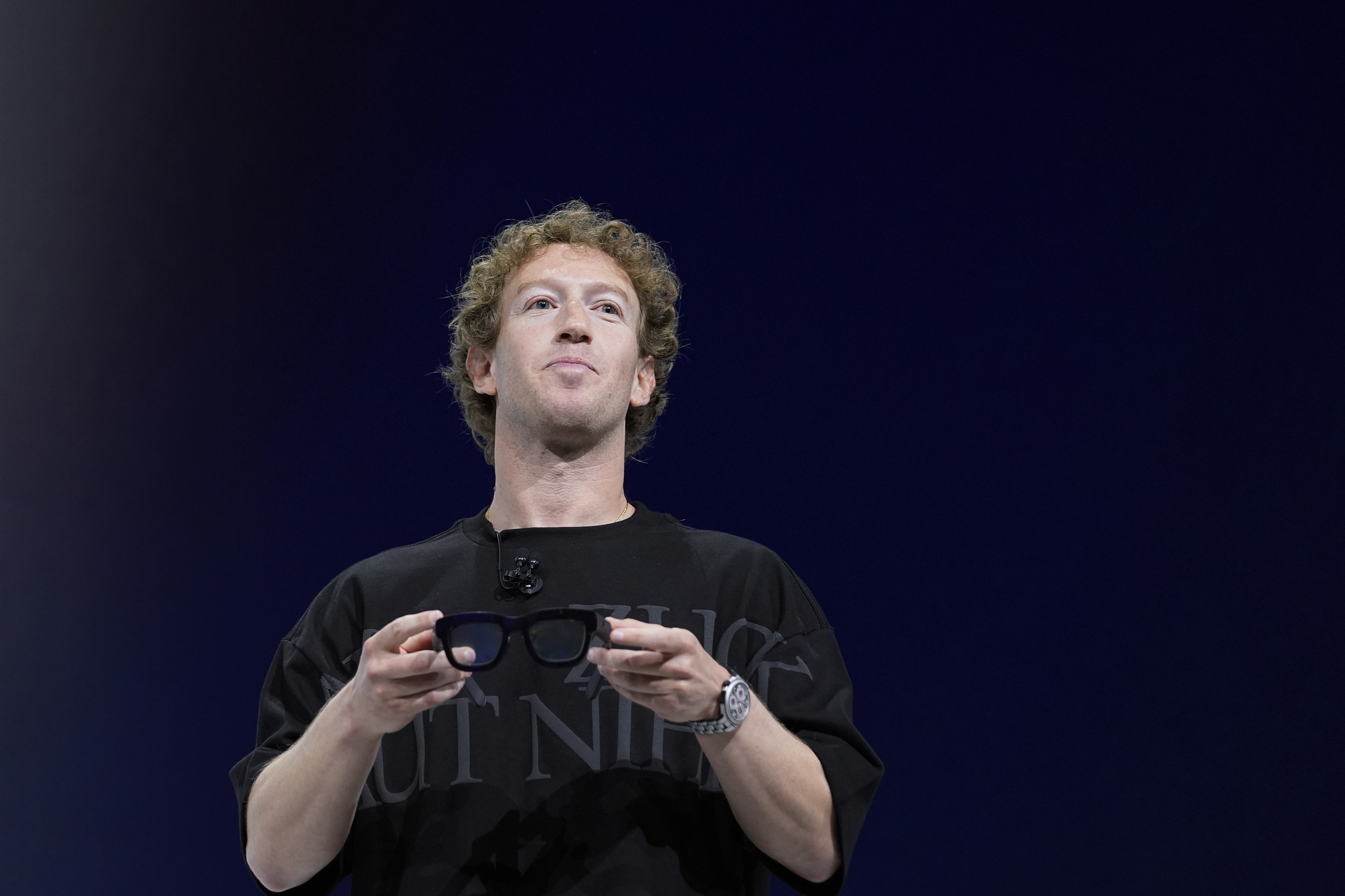 FILE - Mark Zuckerberg holds a pair of Orion AR glasses during the Meta Connect conferenceSept. 25, 2024, in Menlo Park, Calif. (AP Photo/Godofredo A. Vásquez, File)