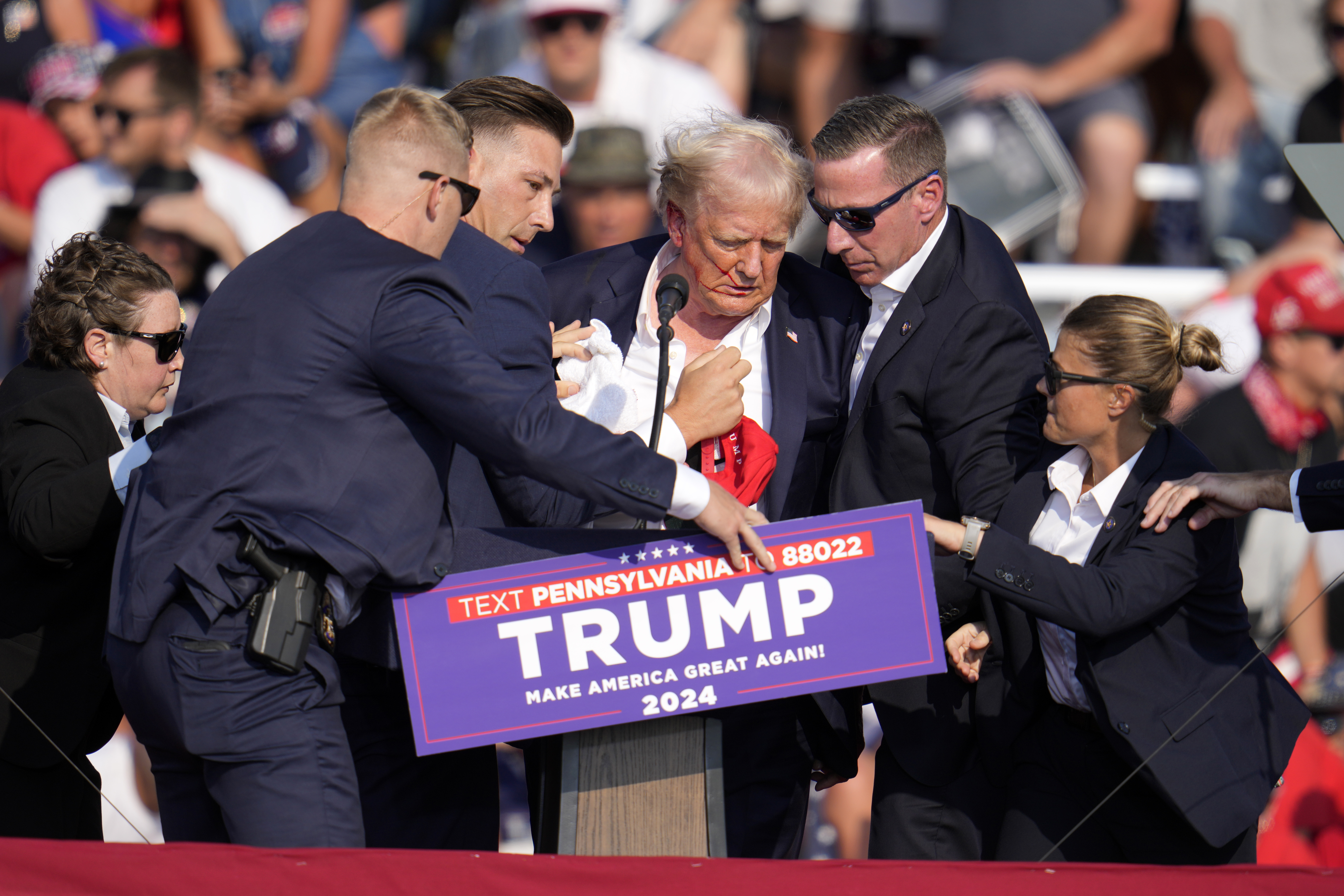 FILE - Republican presidential candidate former President Donald Trump is helped off the stage at a campaign event in Butler, Pa., July 13, 2024. (AP Photo/Gene J. Puskar, File)