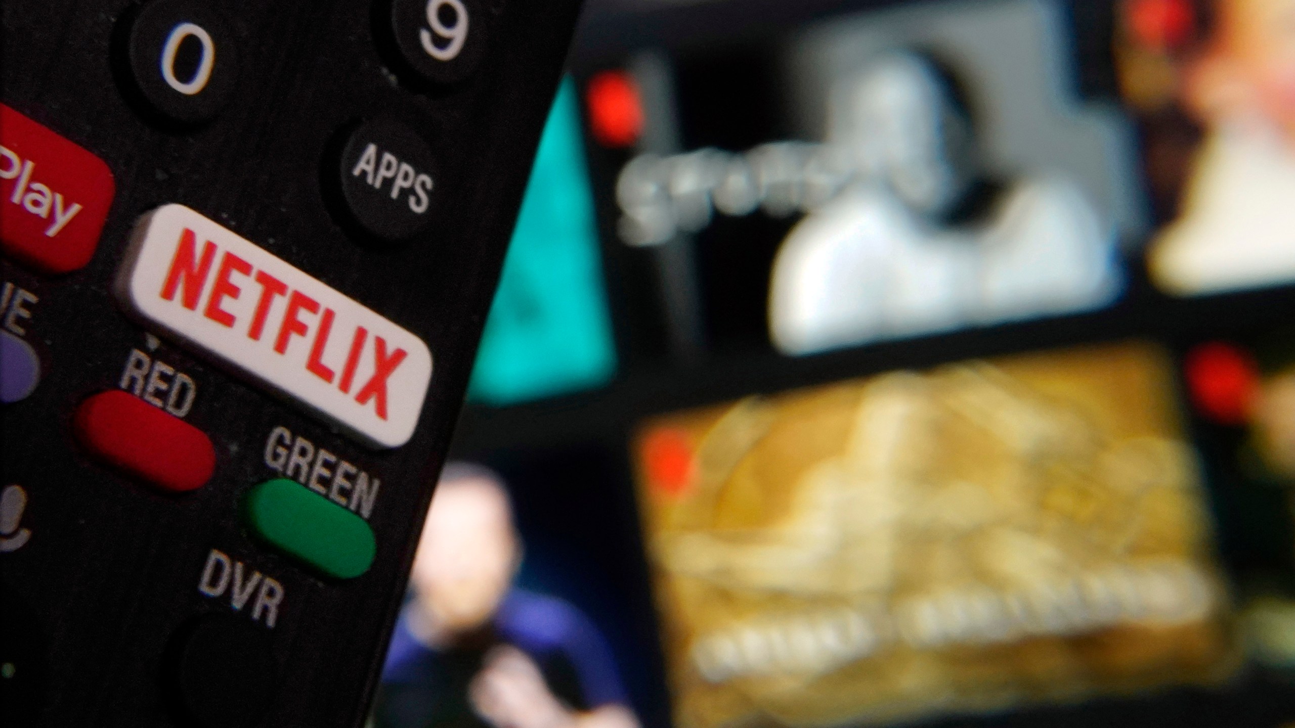 FILE - The Netflix button on a television remote control was juxtaposed with a Netflix web page, in this photo in New York, Feb. 2, 2023. (AP Photo/Richard Drew, File)