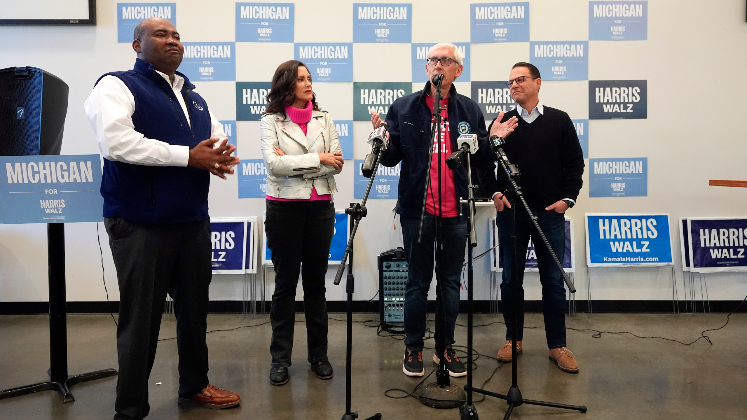 Chair of the Democratic National Committee Jaime Harrison, left, Michigan Gov. Gretchen Whitmer, Wisconsin Gov. Tony Evers and Pennsylvania Gov. Josh Shapiro talk to volunteers during a campaign event, Thursday, Oct. 17, 2024, in Flint, Mich. (AP Photo/Carlos Osorio)