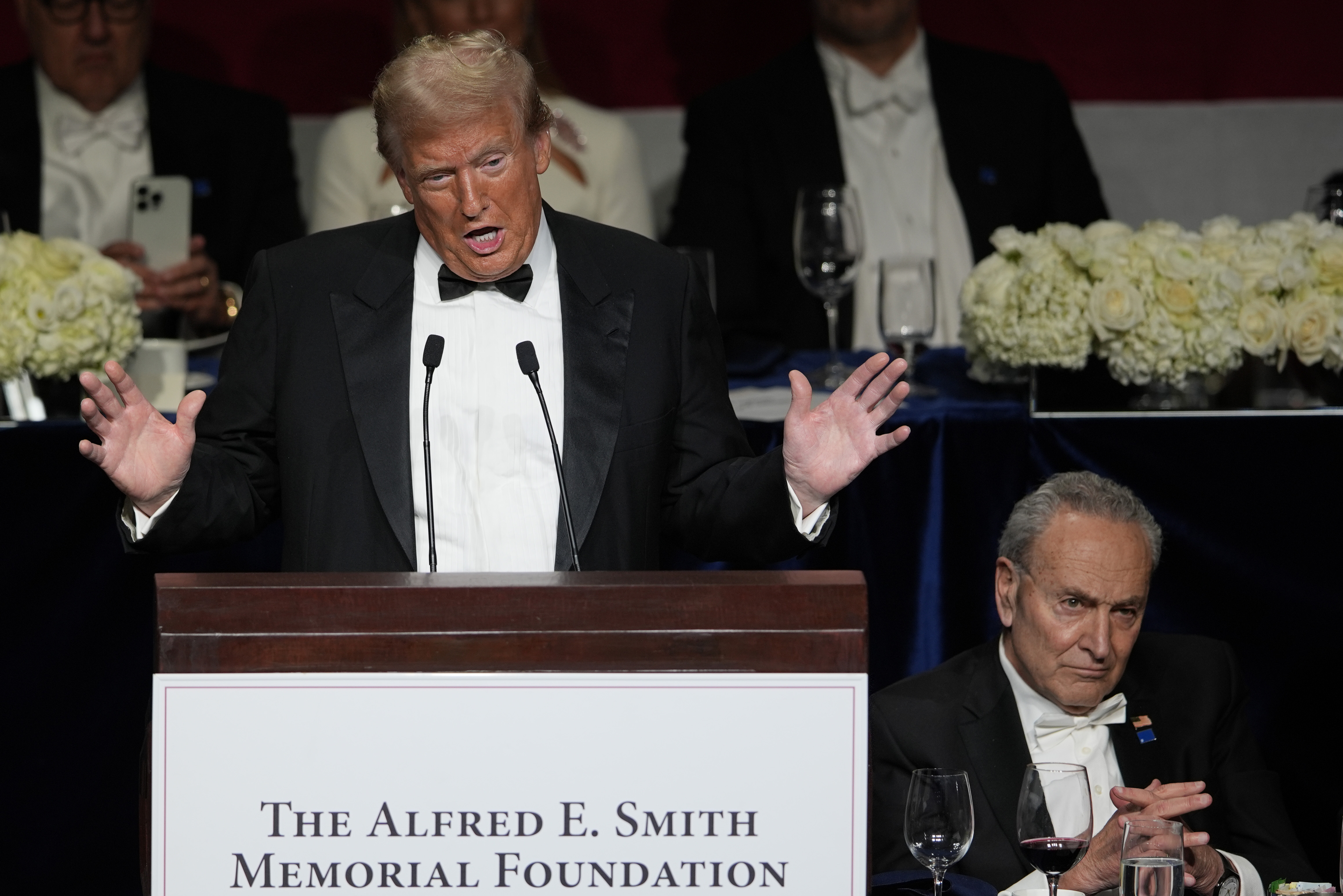 Republican presidential nominee former President Donald Trump speaks as Senate Majority Leader Chuck Schumer of N.Y., listens at the 79th annual Alfred E. Smith Memorial Foundation Dinner, Thursday, Oct. 17, 2024, in New York. (AP Photo/Julia Demaree Nikhinson)