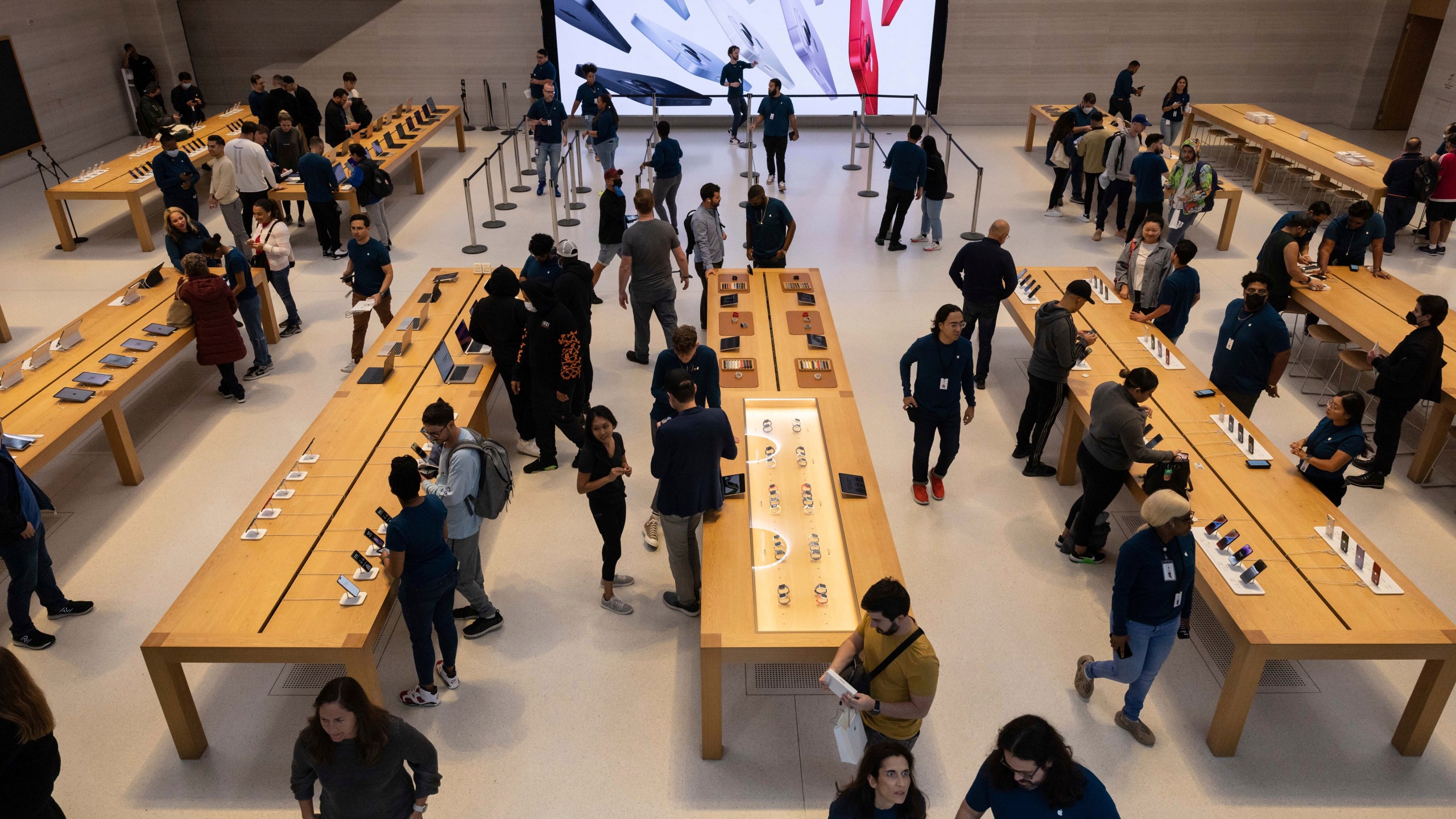 FILE - People gather at an Apple store for the release of the iPhone 14 on Sept. 16, 2022, in New York. (AP Photo/Yuki Iwamura, File)