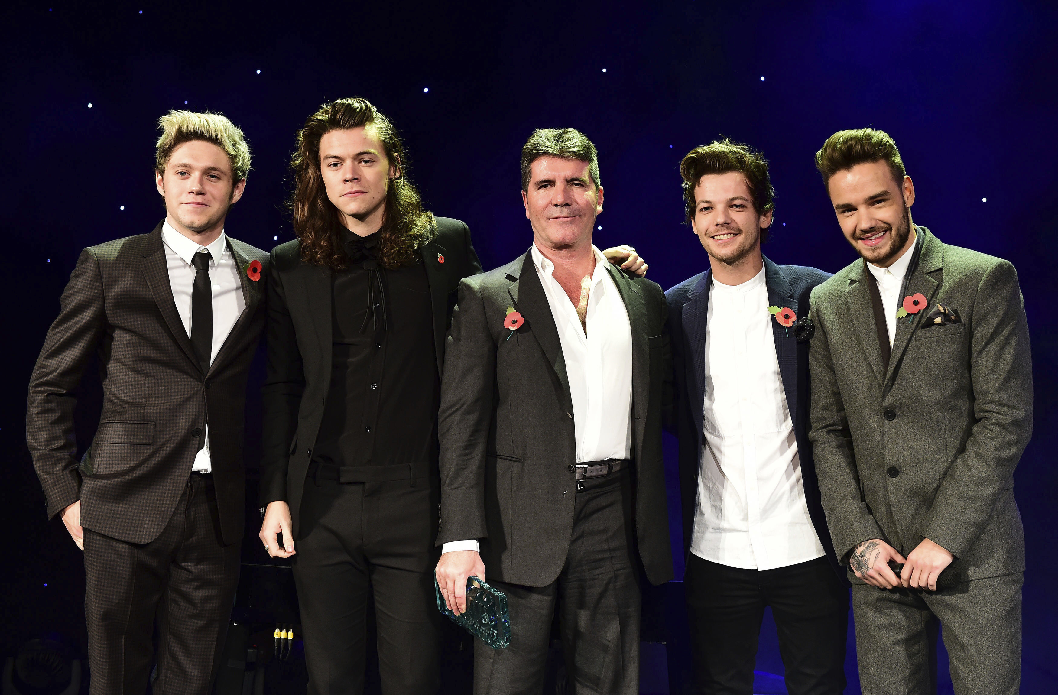 FILE - One Direction's Niall Horan, from left, Harry Styles , Simon Cowell, Louis Tomlinson and Liam Payne present the Music Industry Trust Award to Simon Cowell at the Music Industry Trusts Award (MITS) in aid of charities Nordon Robbins and Brit Trust at the Grosvenor House Hotel, in London, Nov. 2, 2015. (Dominic Lipinski/PA via AP)