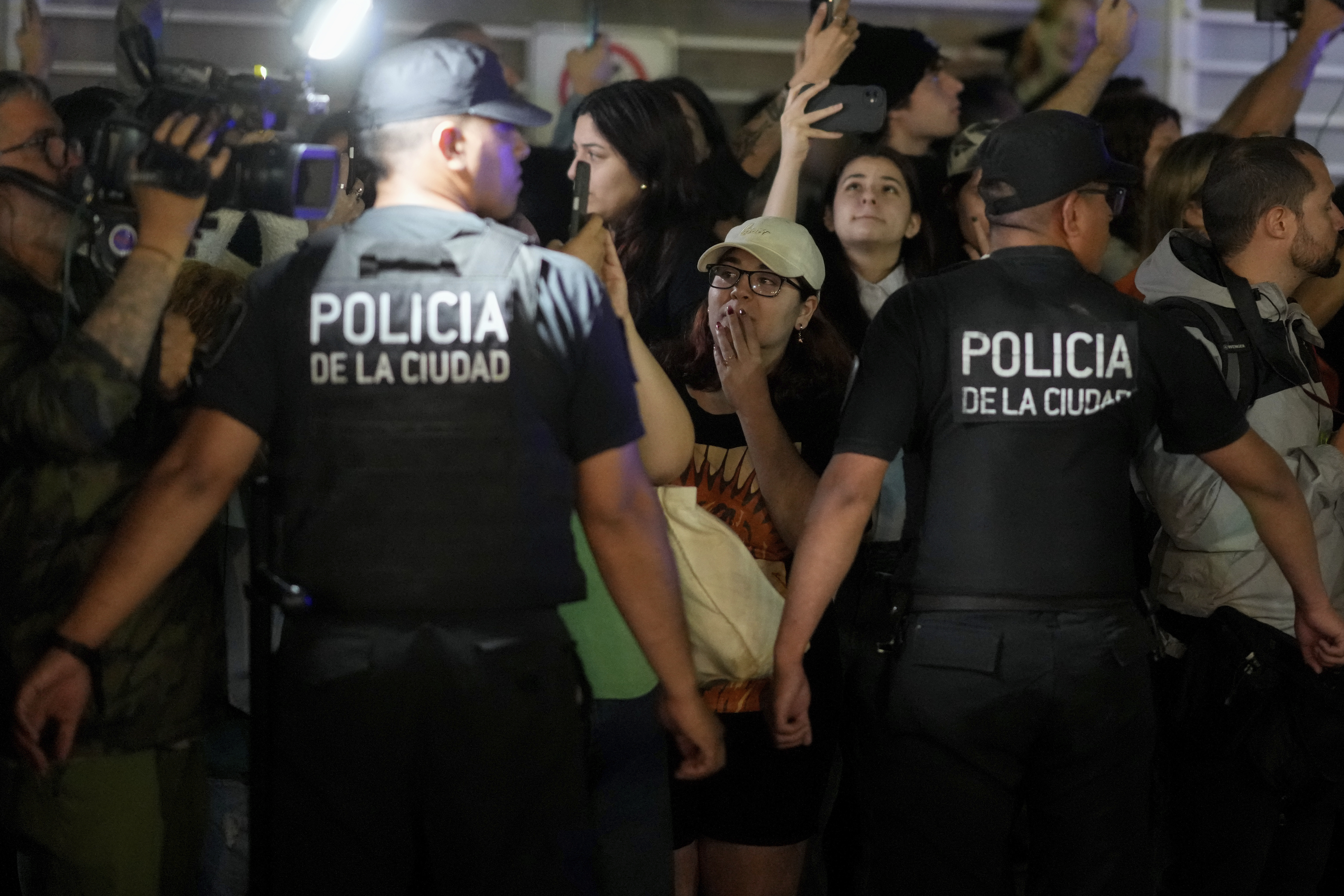 Police restrain fans gathering outside the hotel where former One Direction singer Liam Payne was found dead after he fell from a balcony in Buenos Aires, Argentina, Wednesday, Oct. 16, 2024. (AP Photo/Natacha Pisarenko)