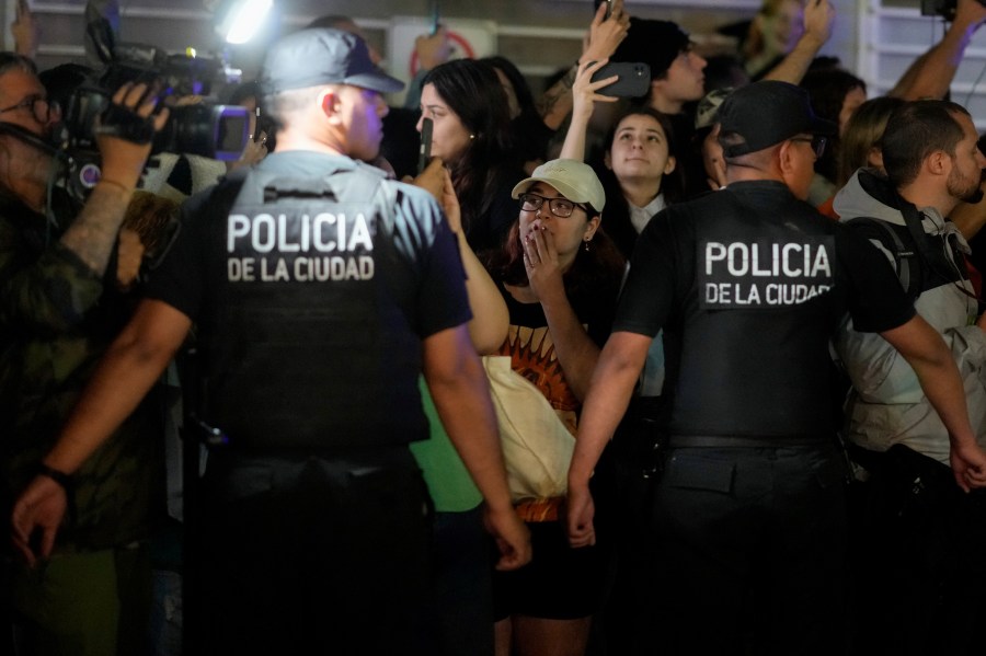 Police restrain fans gathering outside the hotel where former One Direction singer Liam Payne was found dead after he fell from a balcony in Buenos Aires, Argentina, Wednesday, Oct. 16, 2024. (AP Photo/Natacha Pisarenko)