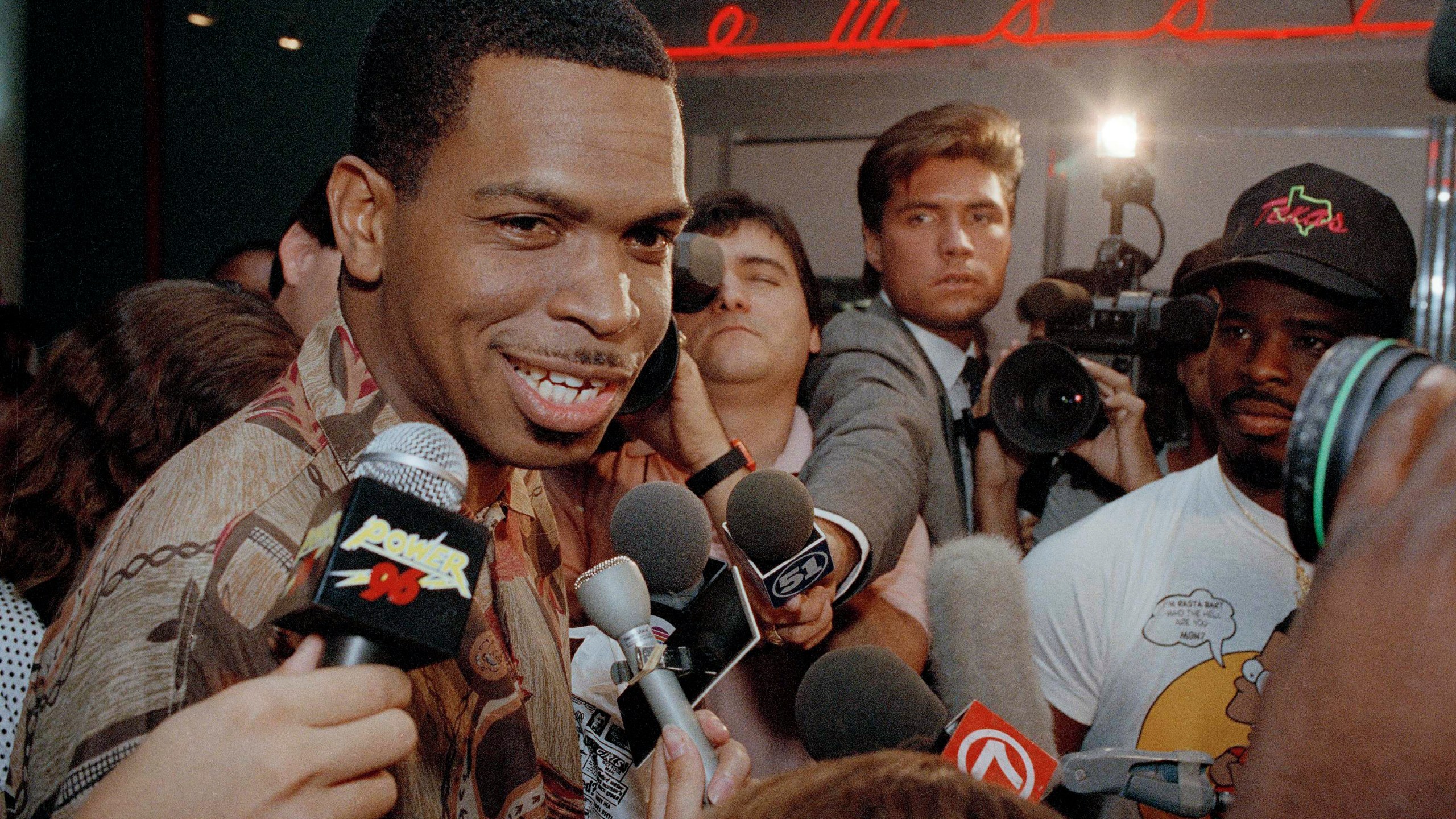 FILE - Luther Campbell, aka Luke Skyywalker, lead singer of the rap group 2 Live Crew is surrounded by a sea of microphones after meeting other band members at Miami International Airport, June 11, 1990. (AP Photo/Chris O'Meara, File)