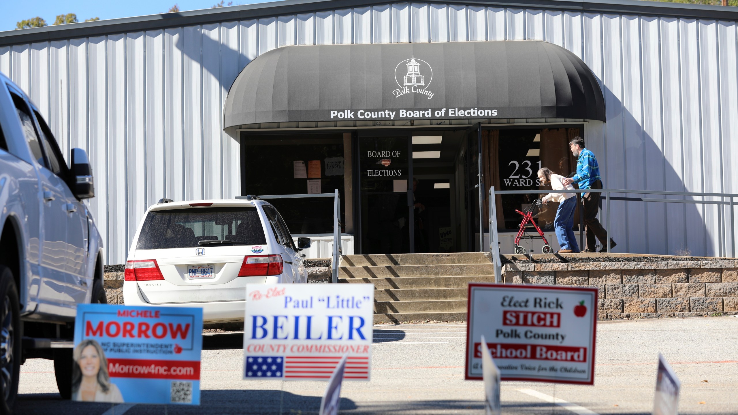 People head inside the Polk County, North Carolina, Board of Elections on the first day of early voting in the state on Thursday, Oct. 17, 2024, in Columbus, N.C. (AP Photo/Jeffrey Collins)