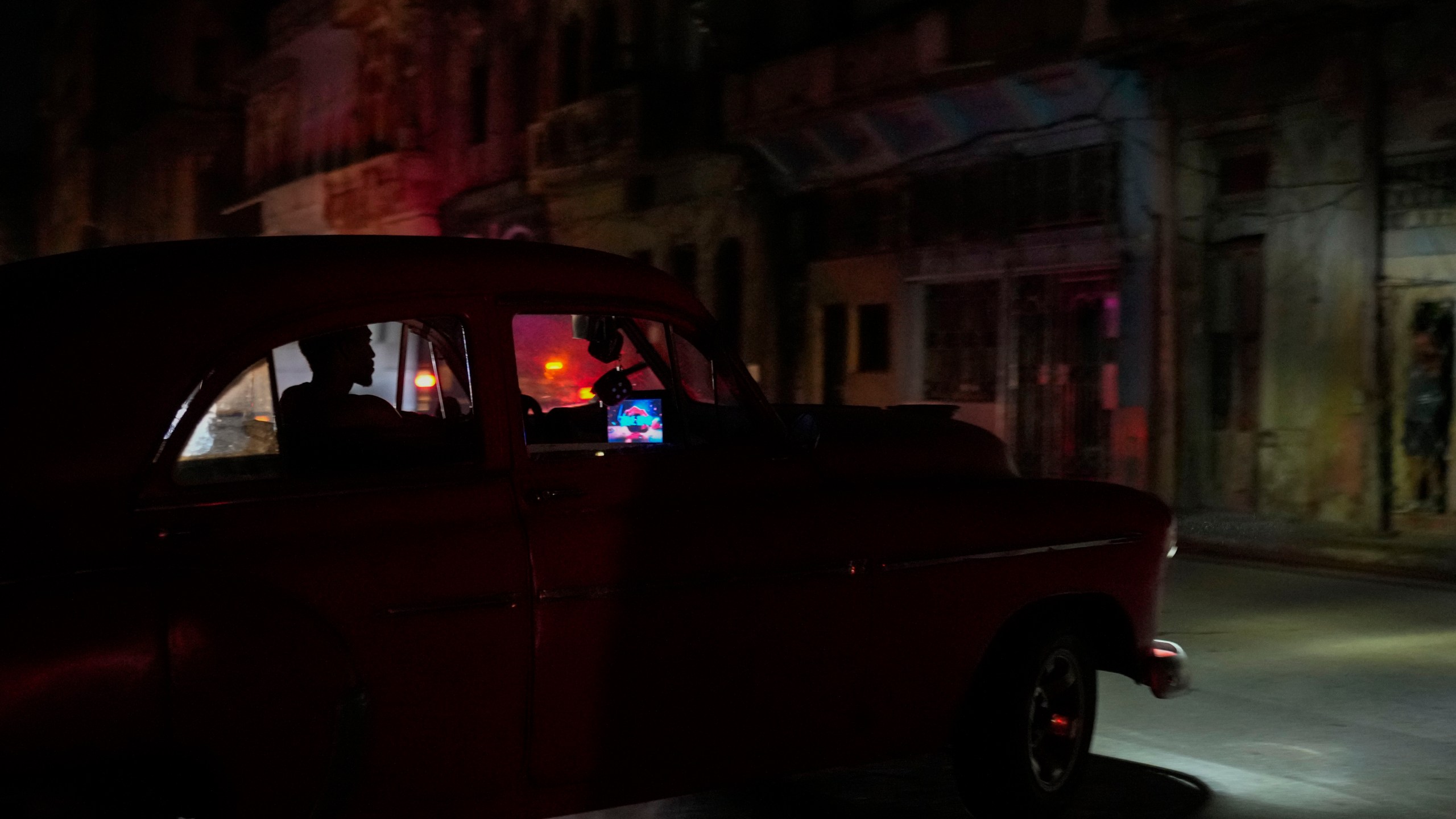 A man drives his American classic car during a massive blackout after a major power plant failed in Havana, Cuba, Friday, Oct. 18, 2024. (AP Photo/Ramon Espinosa)