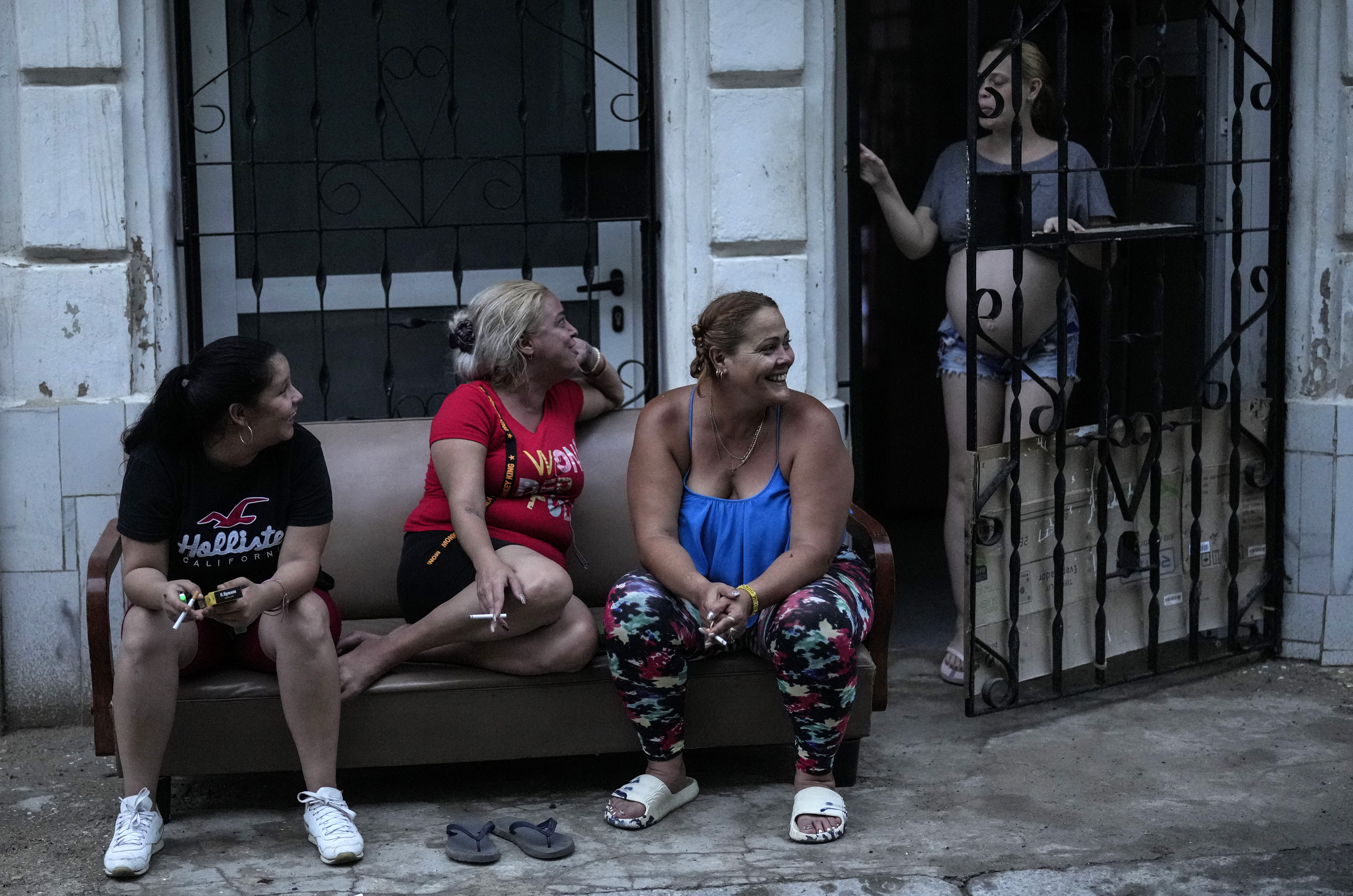 Residents pass the time during a massive blackout after a major power plant failed in Havana, Cuba, Friday, Oct. 18, 2024. (AP Photo/Ramon Espinosa)