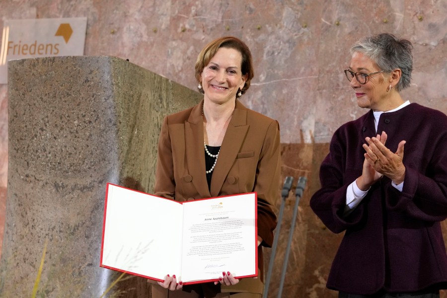 American journalist and historian Anne Applebaum, left, is awarded with the Peace Prize of the German Book Trade by Karin Schmidt-Friderichs, head of the German Publishers and Booksellers Association during a ceremony at the St. Paul's Church in Frankfurt, Germany, Sunday, Oct. 20, 2024.(AP Photo/Martin Meissner, Pool)