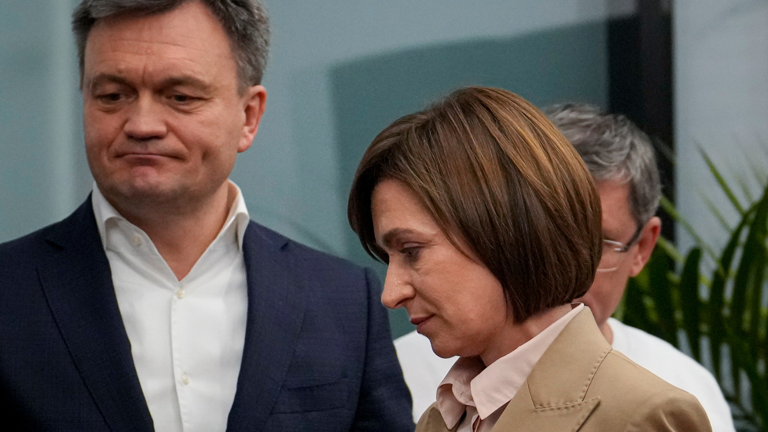 Moldova's President Maia Sandu, right, walks by Moldova's Prime Minister Dorin Recean, left, after the polls closed for the presidential election and the referendum on whether to enshrine in the Constitution the country's path to European Union membership, in Chisinau, Moldova, Monday, Oct. 21, 2024. (AP Photo/Vadim Ghirda)