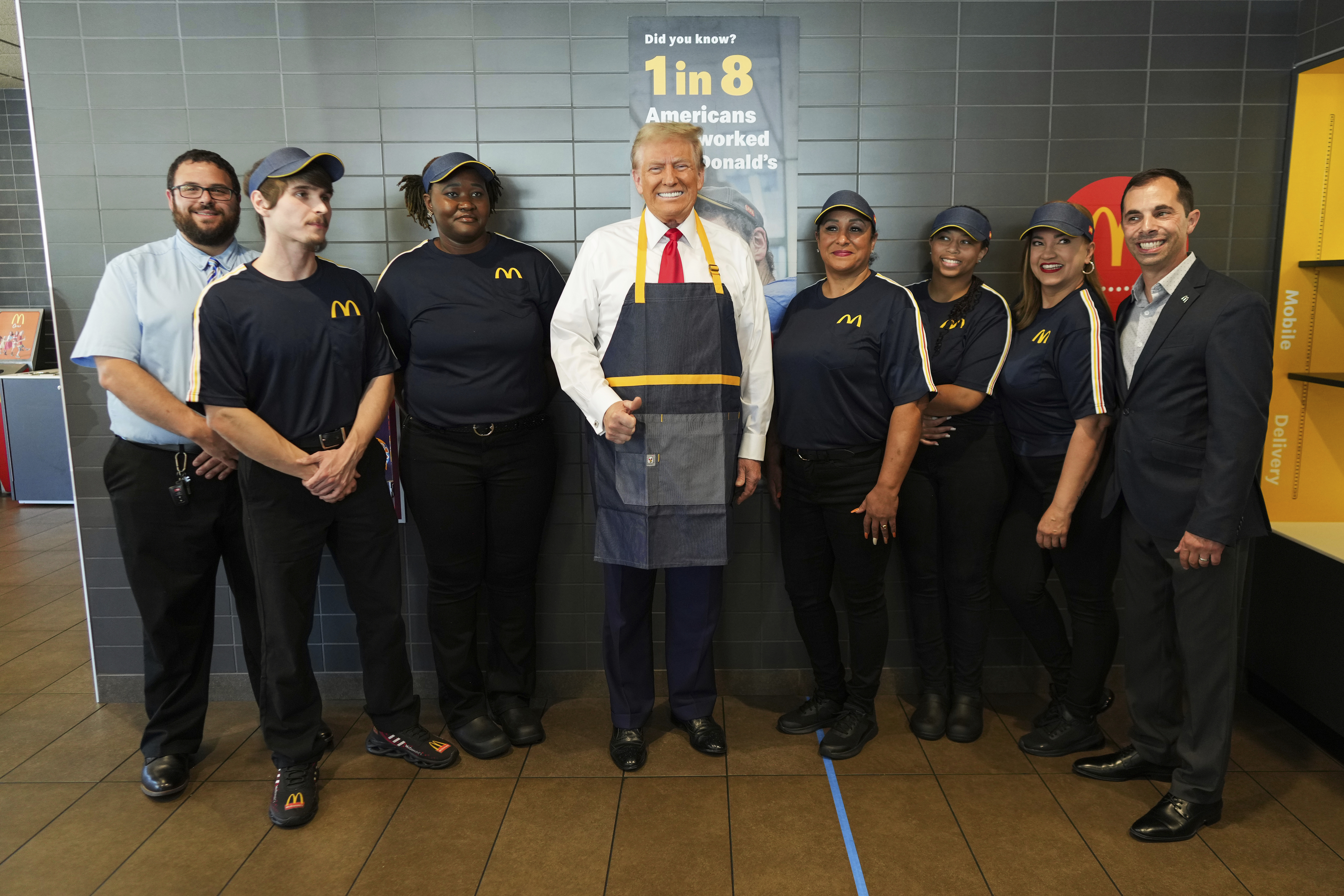 Republican presidential nominee former President Donald Trump poses with employees during a visit to McDonald's in Feasterville-Trevose, Pa., Sunday, Oct. 20, 2024. (Doug Mills/The New York Times via AP, Pool)