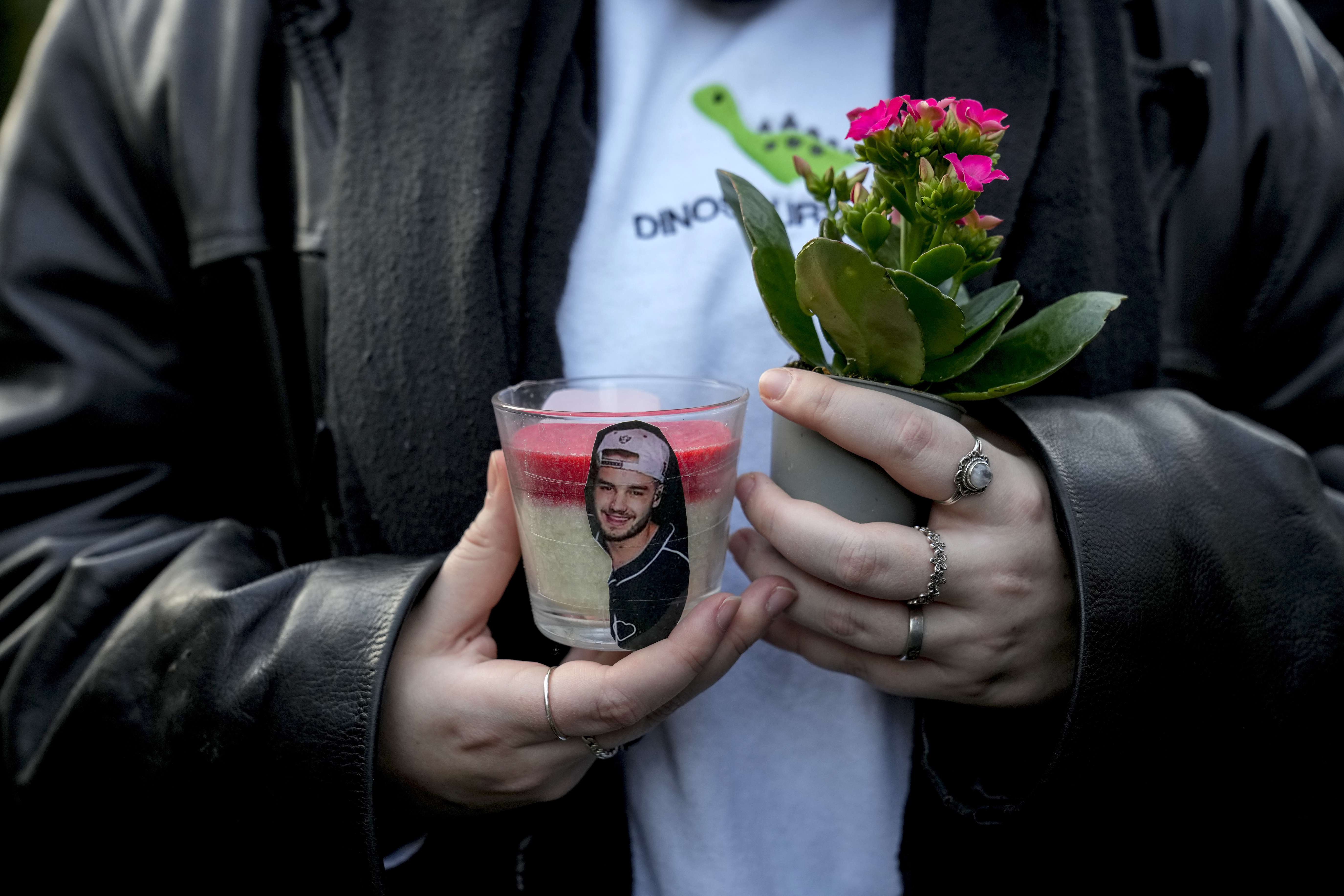 A fan pays tribute to late British singer Liam Payne, former member of the British pop band One Direction in Treptower Park in Berlin, Germany, Sunday, Oct. 20, 2024. (AP Photo/Ebrahim Noroozi)