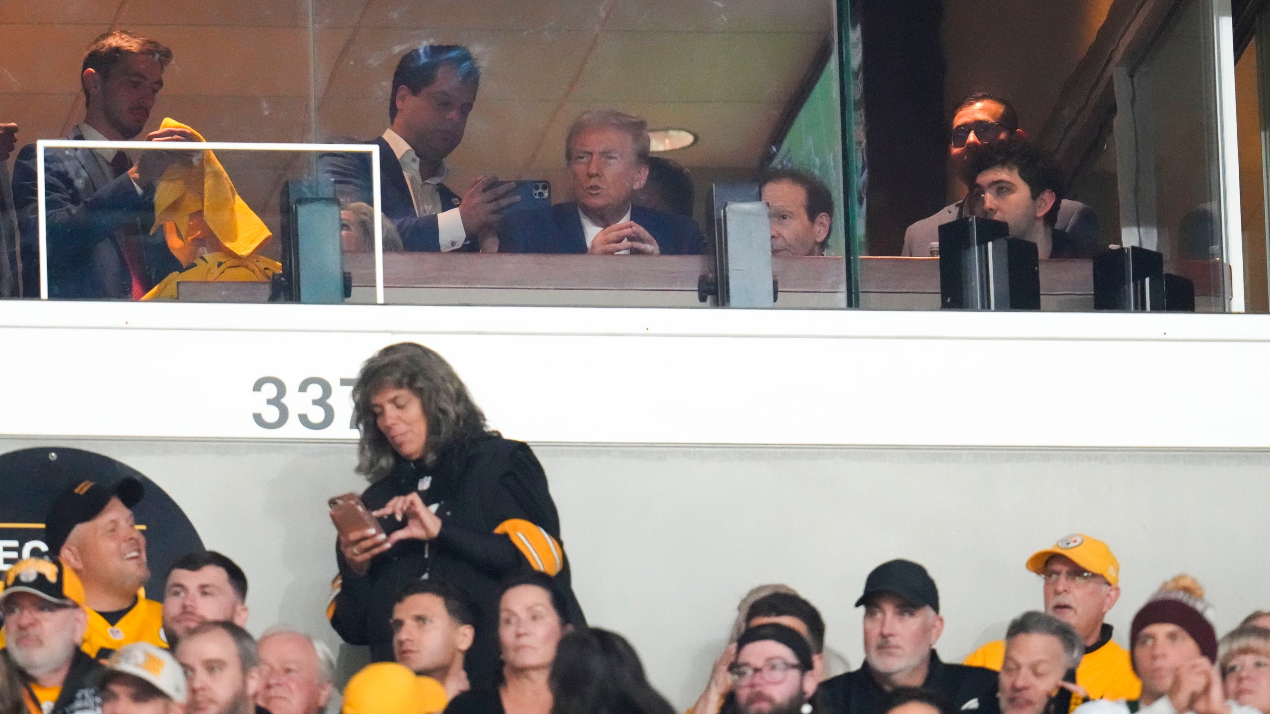 Republican presidential nominee former President Donald Trump watches the first half of an NFL football game between the Pittsburgh Steelers and the New York Jets in Pittsburgh, Sunday, Oct. 20, 2024. (AP Photo/Gene J. Puskar)