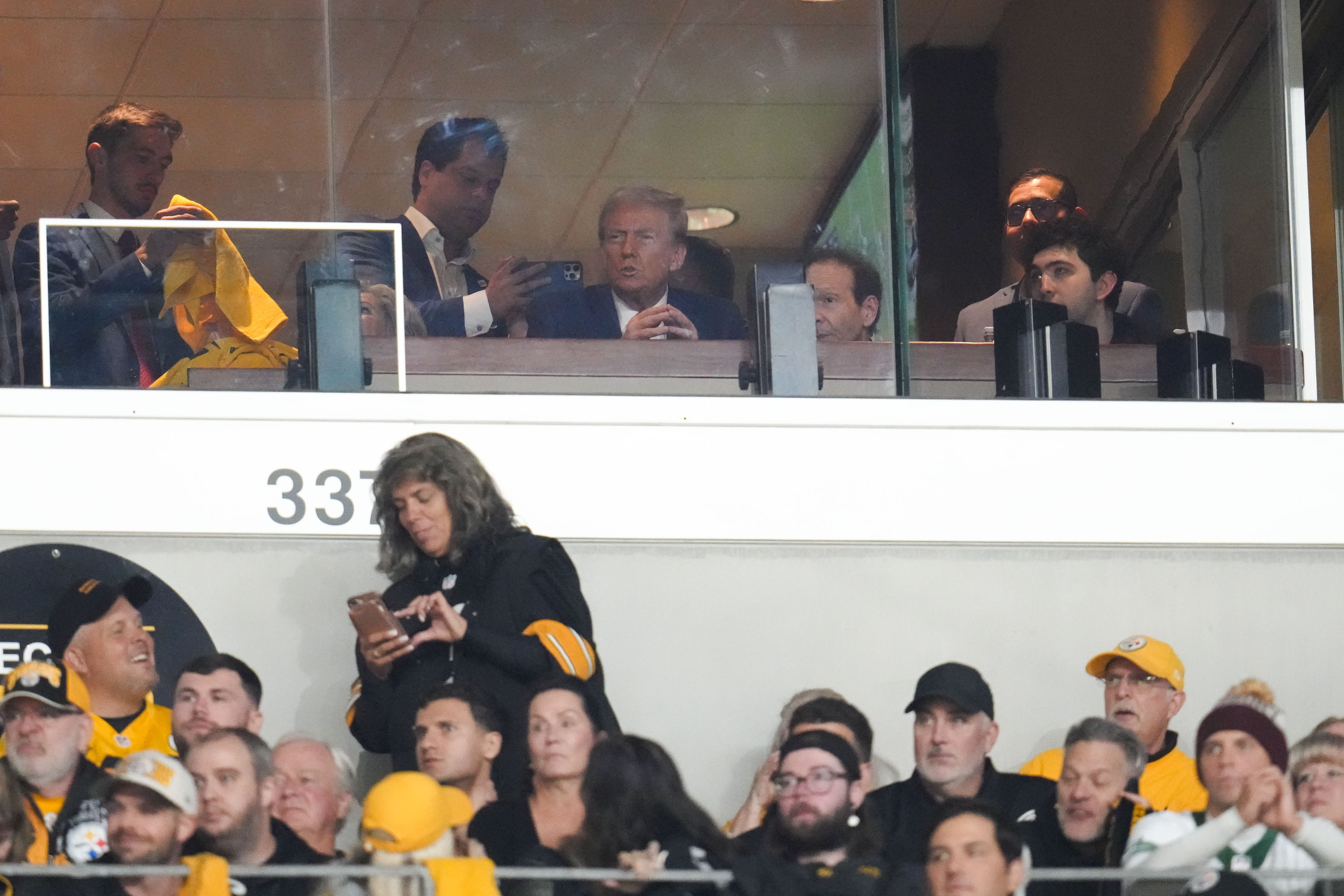 Republican presidential nominee former President Donald Trump watches the first half of an NFL football game between the Pittsburgh Steelers and the New York Jets in Pittsburgh, Sunday, Oct. 20, 2024. (AP Photo/Gene J. Puskar)