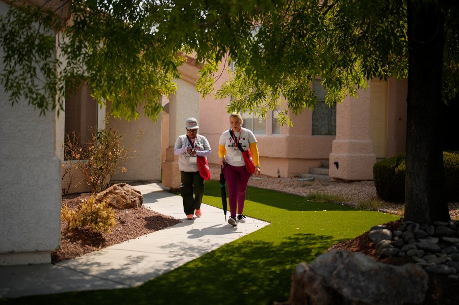 Florisela Lopez Rivera, left, canvasses with fellow Culinary Workers Union member Suldenil Alvarez, Tuesday, Sept. 10, 2024, in Las Vegas. Originally from El Salvador, Lopez Rivera recently gained permanent U.S. residency after her wife became a citizen. (AP Photo/John Locher)