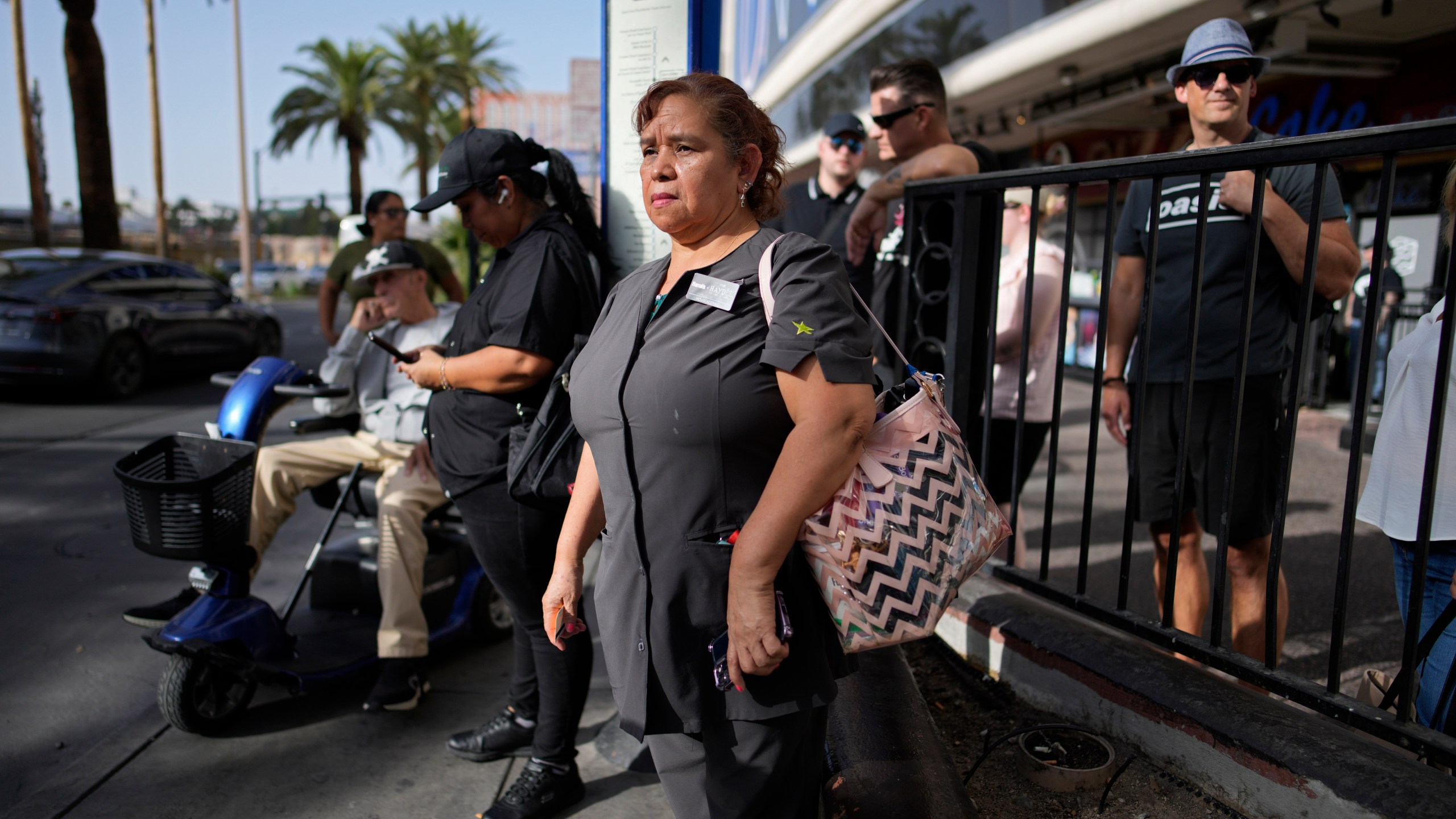 Haydee Zetino waits for the bus after working a shift as a maid at Harrah's hotel-casino along the Las Vegas Strip, Thursday, Sept. 12, 2024, in Las Vegas. Zetino, an immigrant from El Salvador, gained temporary protected status since arriving in the wake of a major earthquake in 2001. (AP Photo/John Locher)