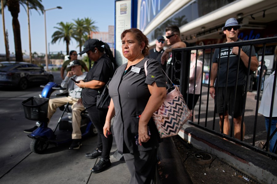 Haydee Zetino waits for the bus after working a shift as a maid at Harrah's hotel-casino along the Las Vegas Strip, Thursday, Sept. 12, 2024, in Las Vegas. Zetino, an immigrant from El Salvador, gained temporary protected status since arriving in the wake of a major earthquake in 2001. (AP Photo/John Locher)