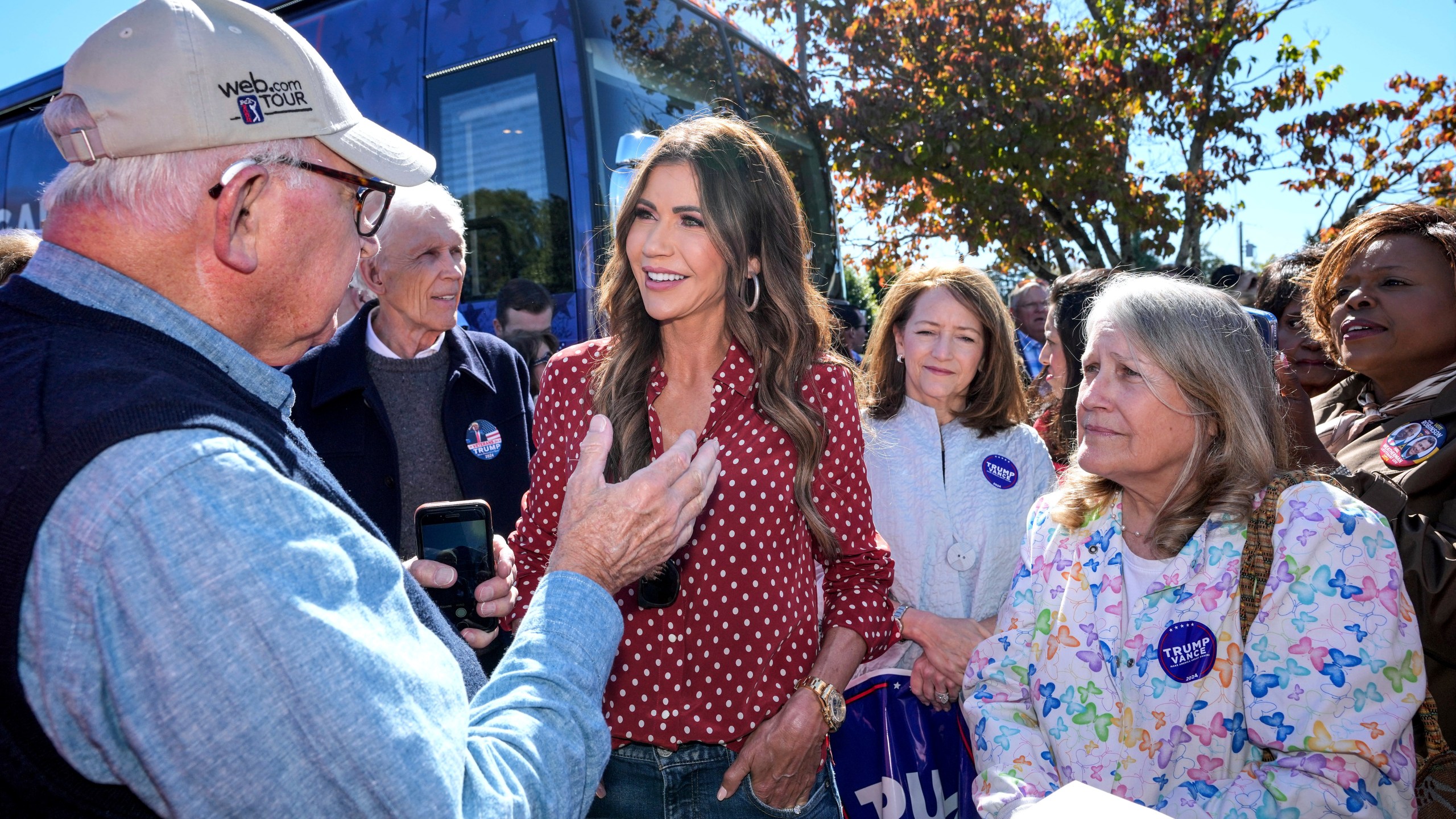 Governor Kristi Noel (SD), third from left, talks with Trump supporter, Tom Dodgen of Rutherfordton, left, at the Team Trump bus tour across North Carolina, Thursday, Oct. 17, 2024 in Rutherfordton, N.C. (AP Photo/Kathy Kmonicek)