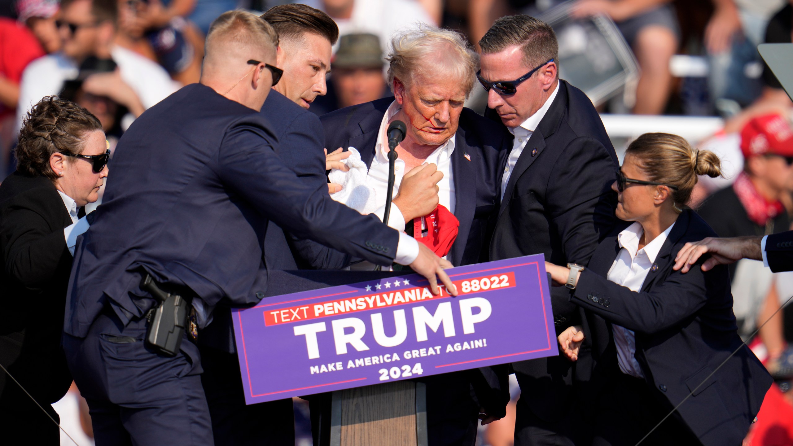 FILE - Republican presidential candidate former President Donald Trump is helped off the stage at a campaign event in Butler, Pa., July 13, 2024. (AP Photo/Gene J. Puskar, File)