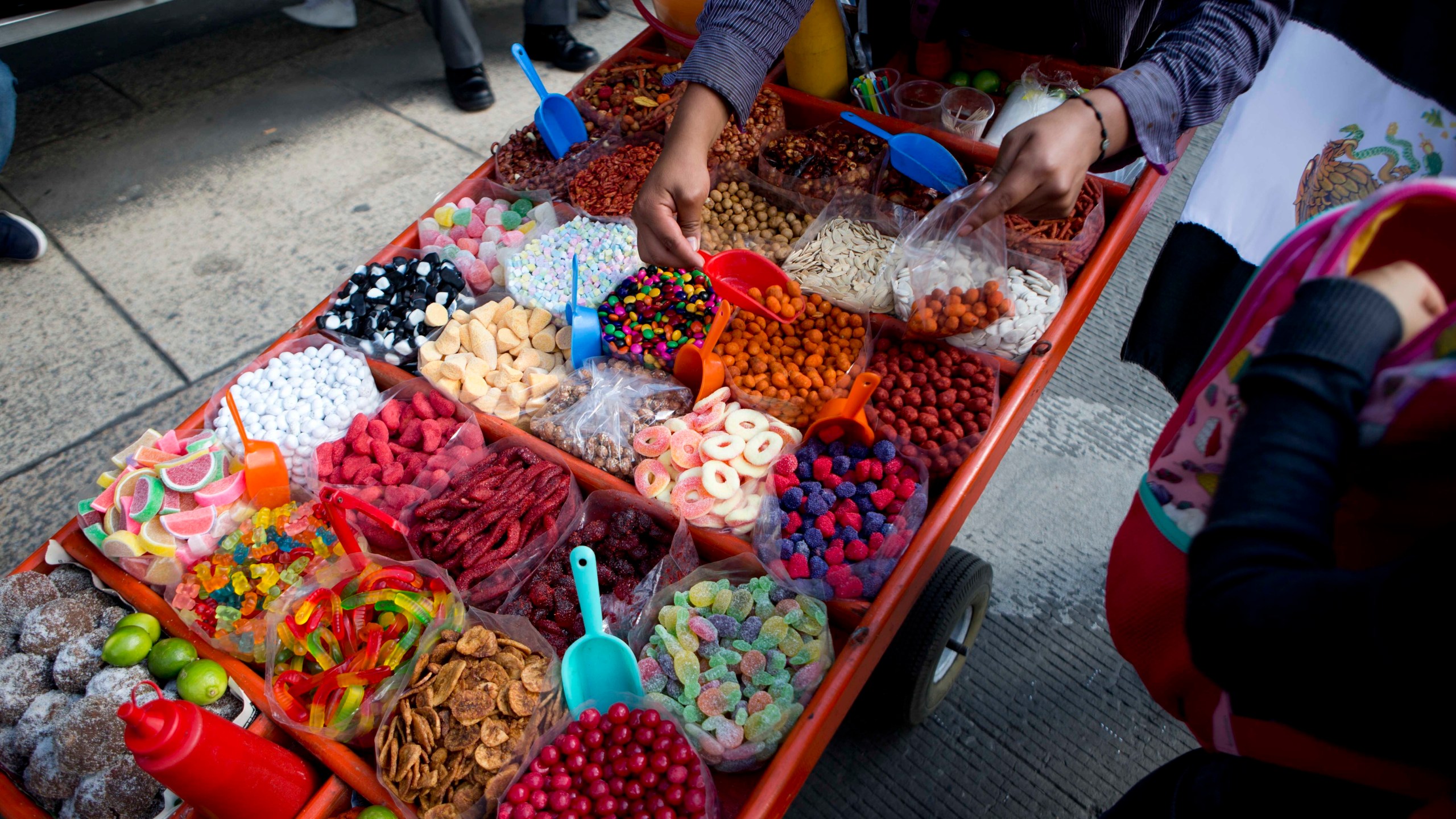 FILE - A street vendor sells sweet snacks in Mexico City, July 5, 2016. (AP Photo/Eduardo Verdugo, File)