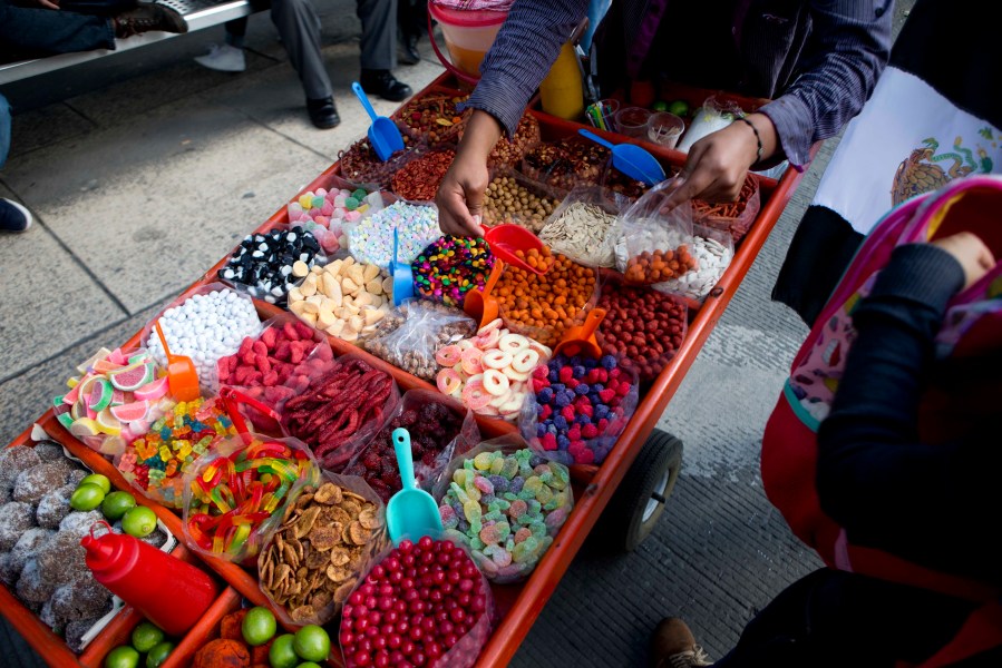 FILE - A street vendor sells sweet snacks in Mexico City, July 5, 2016. (AP Photo/Eduardo Verdugo, File)