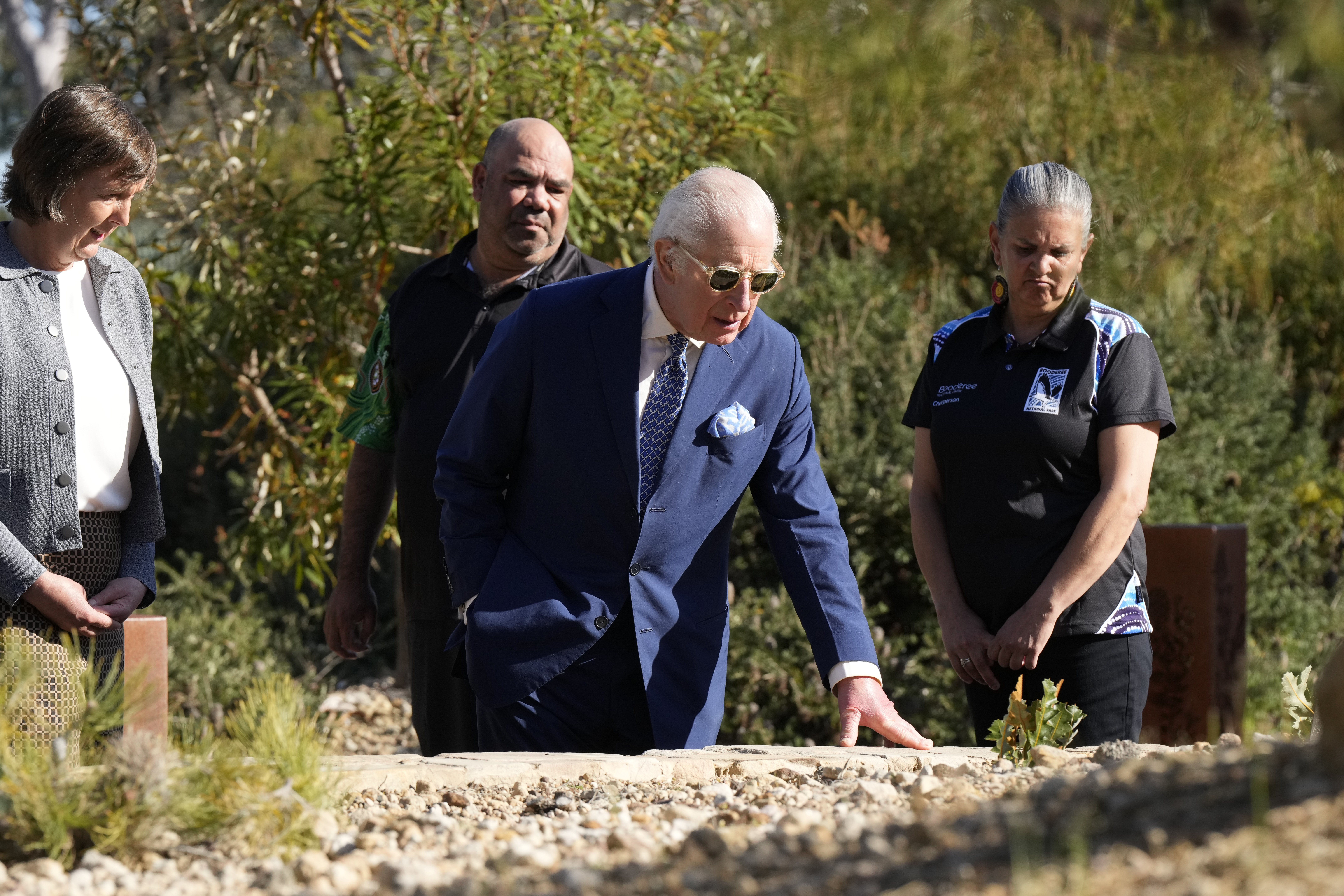 Britain's King Charles III, center, inspect plants during a visit to Australian National Botanic Gardens in Canberra, Monday, Oct. 21, 2024. (AP Photo/Mark Baker, Pool)