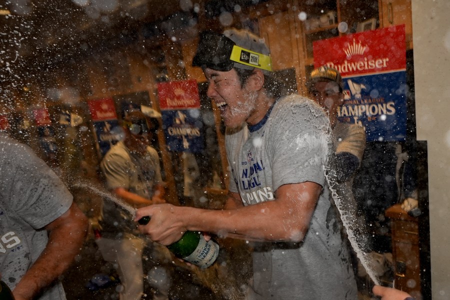 Los Angeles Dodgers Shohei Ohtani celebrates in the locker room after their win against the New York Mets in Game 6 of a baseball NL Championship Series, Sunday, Oct. 20, 2024, in Los Angeles. The Dodgers will face the New York Yankees in the World (AP Photo/Ashley Landis)